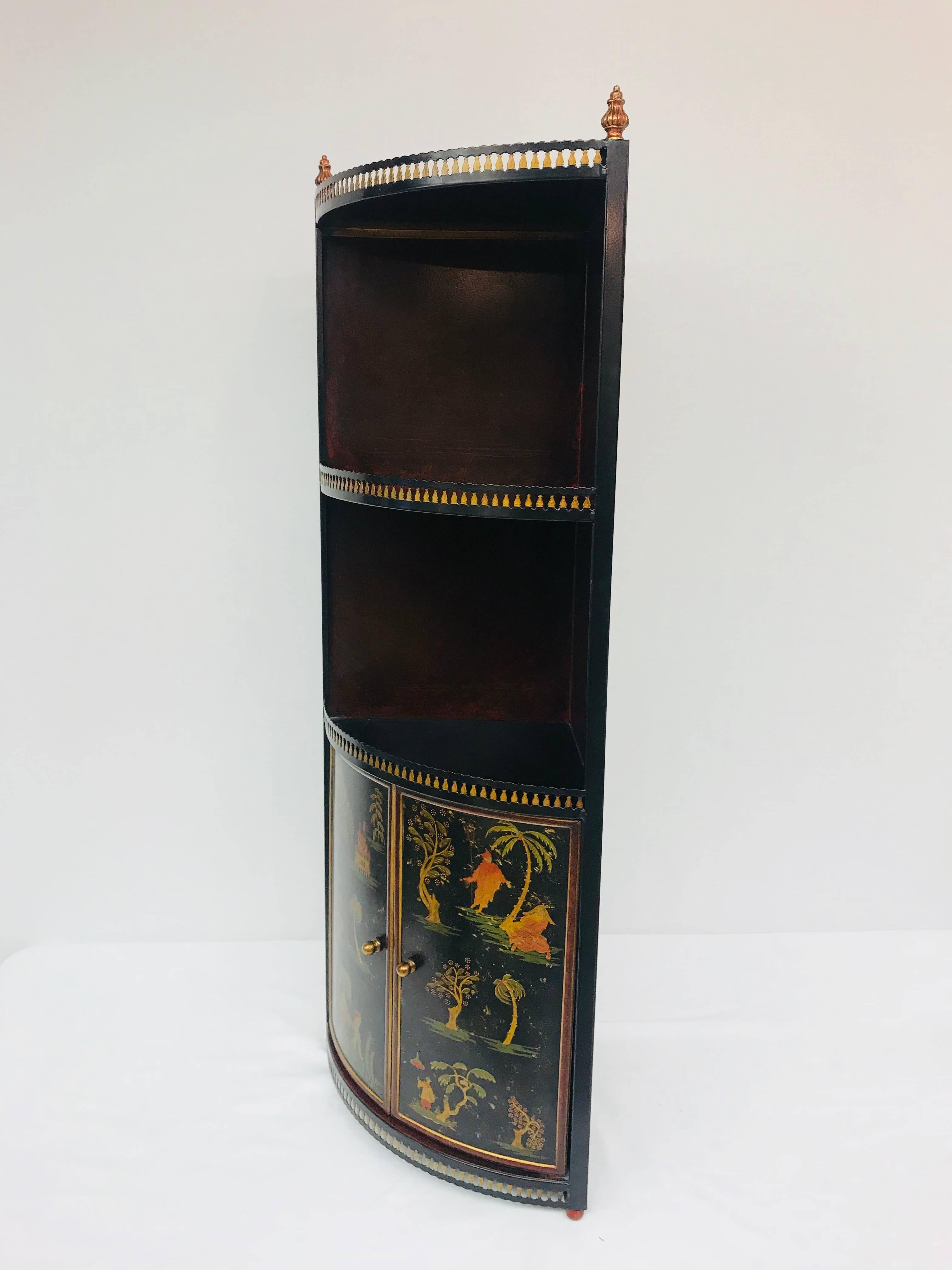 Straight from Italy, circa 1960, this tole corner cabinet features a charming chinoiserie scene. Two open shelves provide display space for a variety of small objects, while the two cabinet doors open to reveal a 15