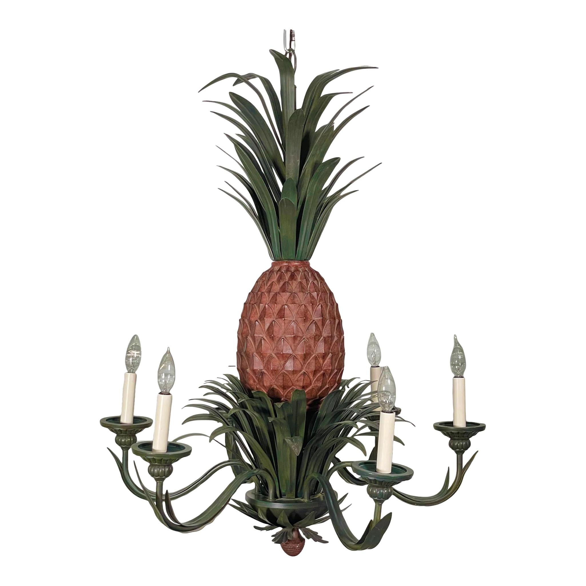Large 6-arm chandelier features a sculptural pineapple center with tole metal fronds above and below. Good condition with imperfections consistent with age, see photos for condition details. We have two of these in stock, enquire if interested.
For
