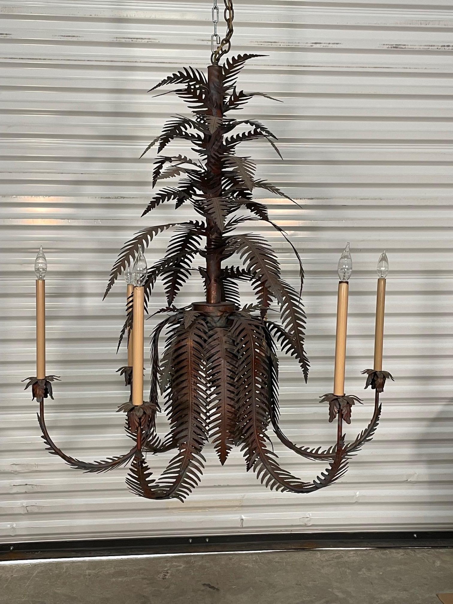 Large tole chandelier features sculptural fern leaves and six arms. A unique twist on traditional tole palm frond chandeliers. Good condition with imperfections consistent with age. May exhibit scuffs, marks, or wear, see photos for details.