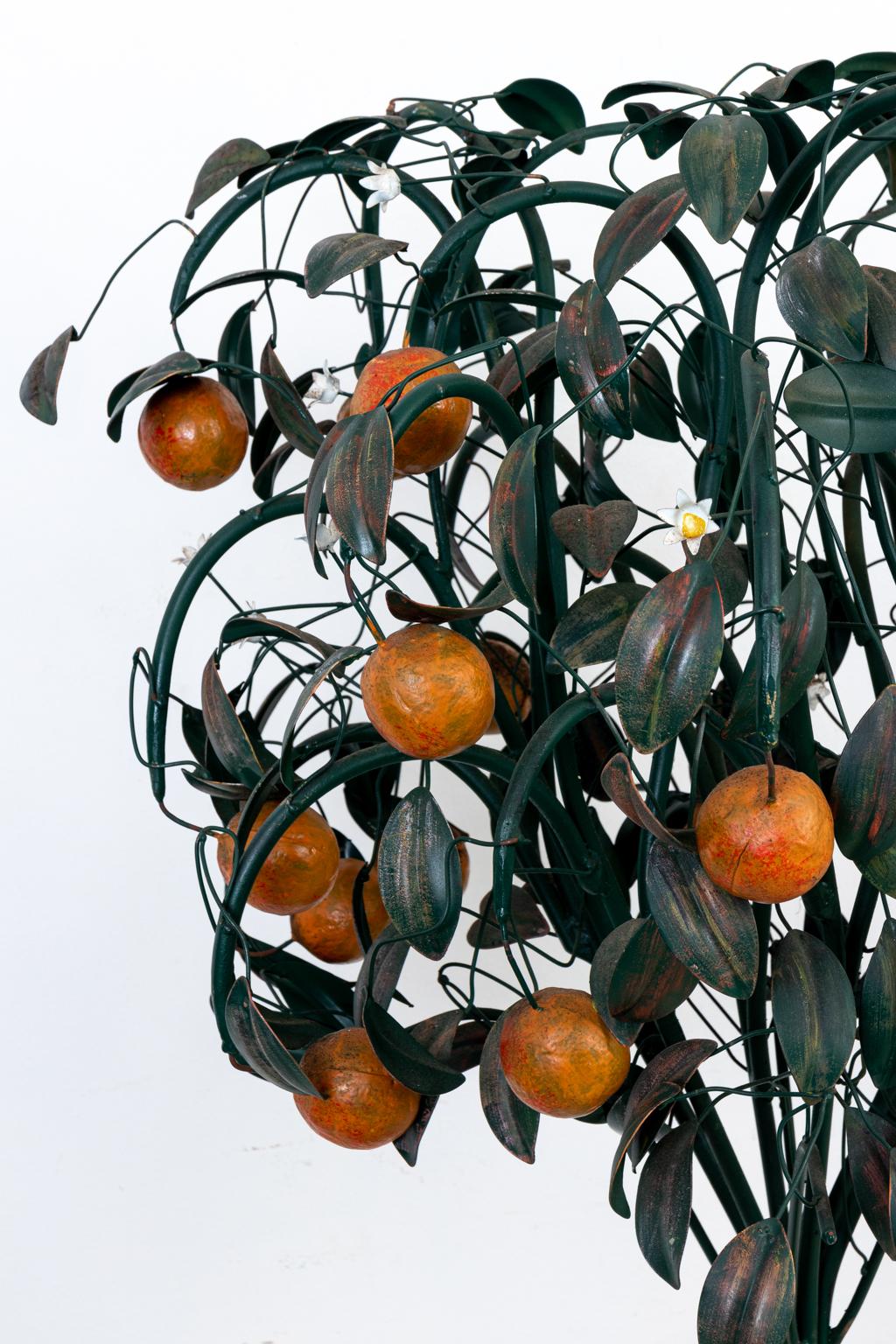 Circa 1940s painted tole orange tree with blossoms. Made in Italy. Please note of wear consistent with age including patina and oxidation to the metal. Highly developed model.