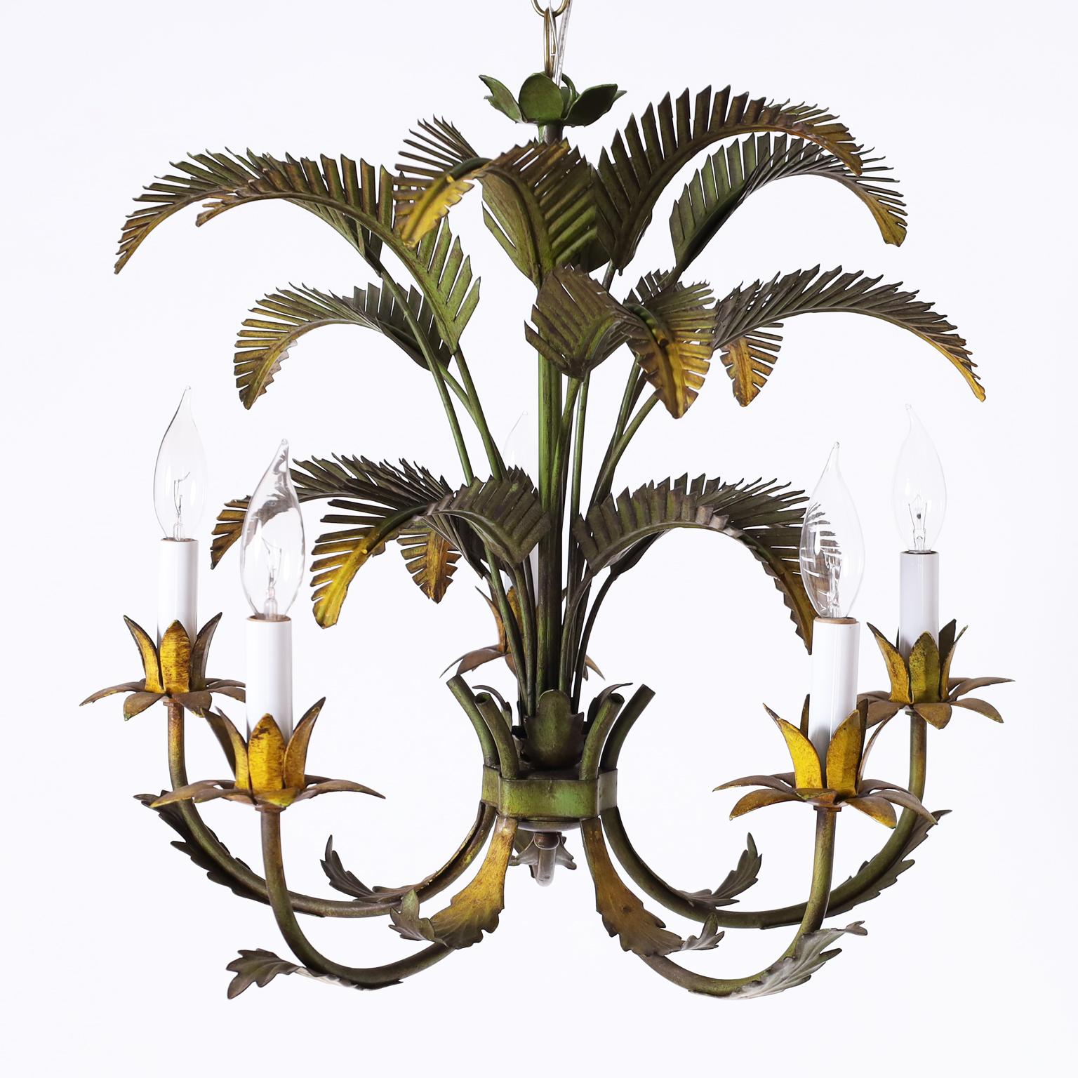 Italian tole five light chandelier with palm leaves over graceful arms with acanthus leaves and floral candle cups all having a rustic aged yellow and green finish.