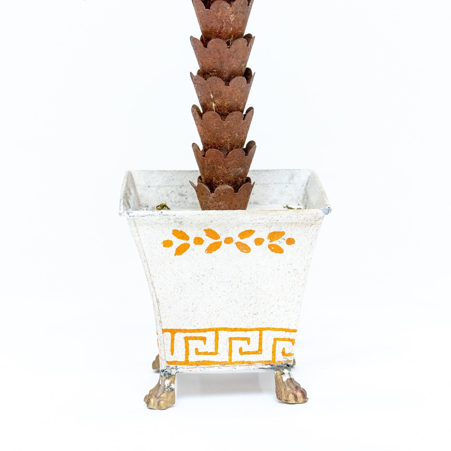 Hand painted tole palm tree in footed planter in the Hollywood Regency style. Made in Italy. Please note wear consistent with age.
 