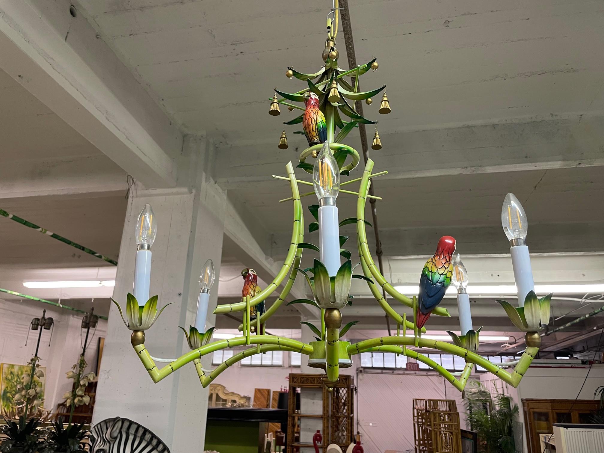 One of a kind hand painted tole chandelier features brightly colored frame with three parrot sculptures and gold tassels. Excellent condition overall (see photos for condition).