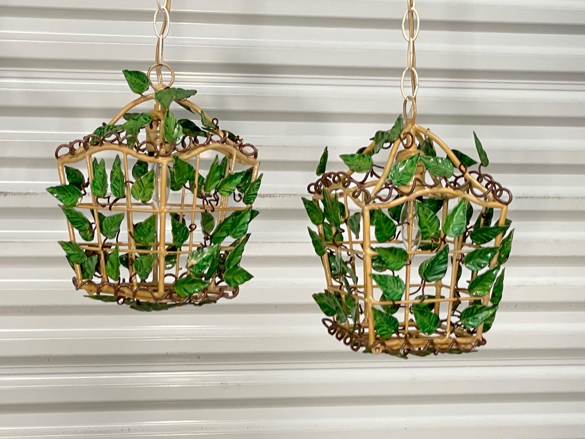 Pair of vintage hand painted pendant lights feature a lantern design with tole vines and leaves throughout. Good condition with imperfections consistent with age, see photos for condition details. 
For a shipping quote to your exact zip code, please