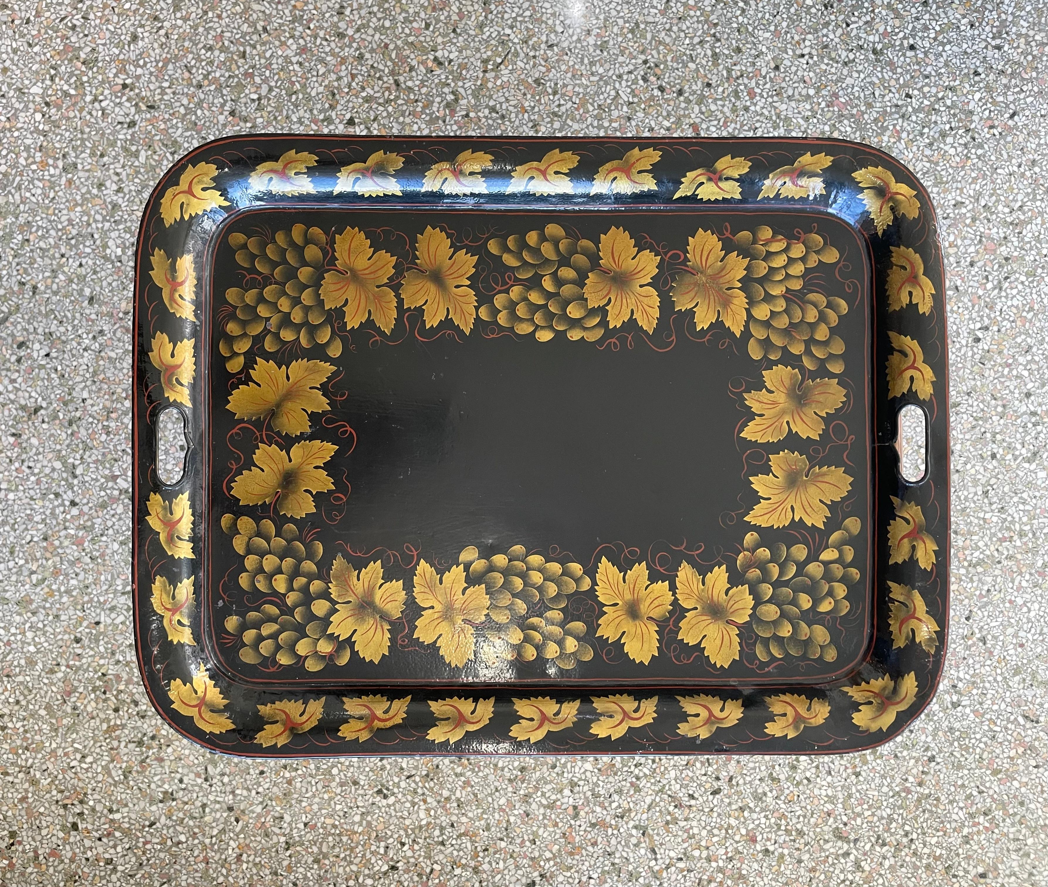 This stylish tole ware tray on stand will make a beautiful statement with its simple form and use of materials.  The tray is not original to the base, and was married at some point in time.  The base most likely originally held an ironstone platter.