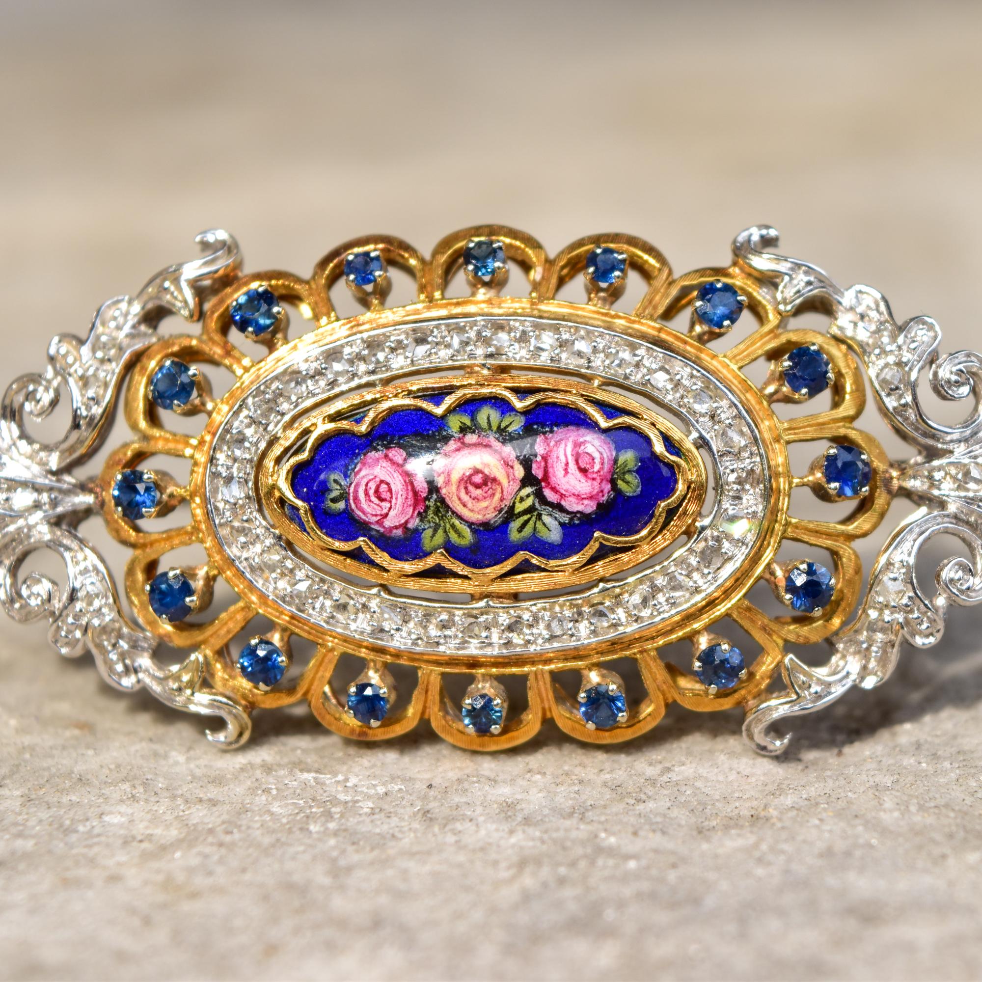A breathtaking 18K diamond encrusted sapphire enamel flower brooch pendant by Toliro Italy. This piece is a true work of art and boasts bright yellow gold scallops, diamond studded white gold embellishments, and a dazzling sapphire halo. The focal