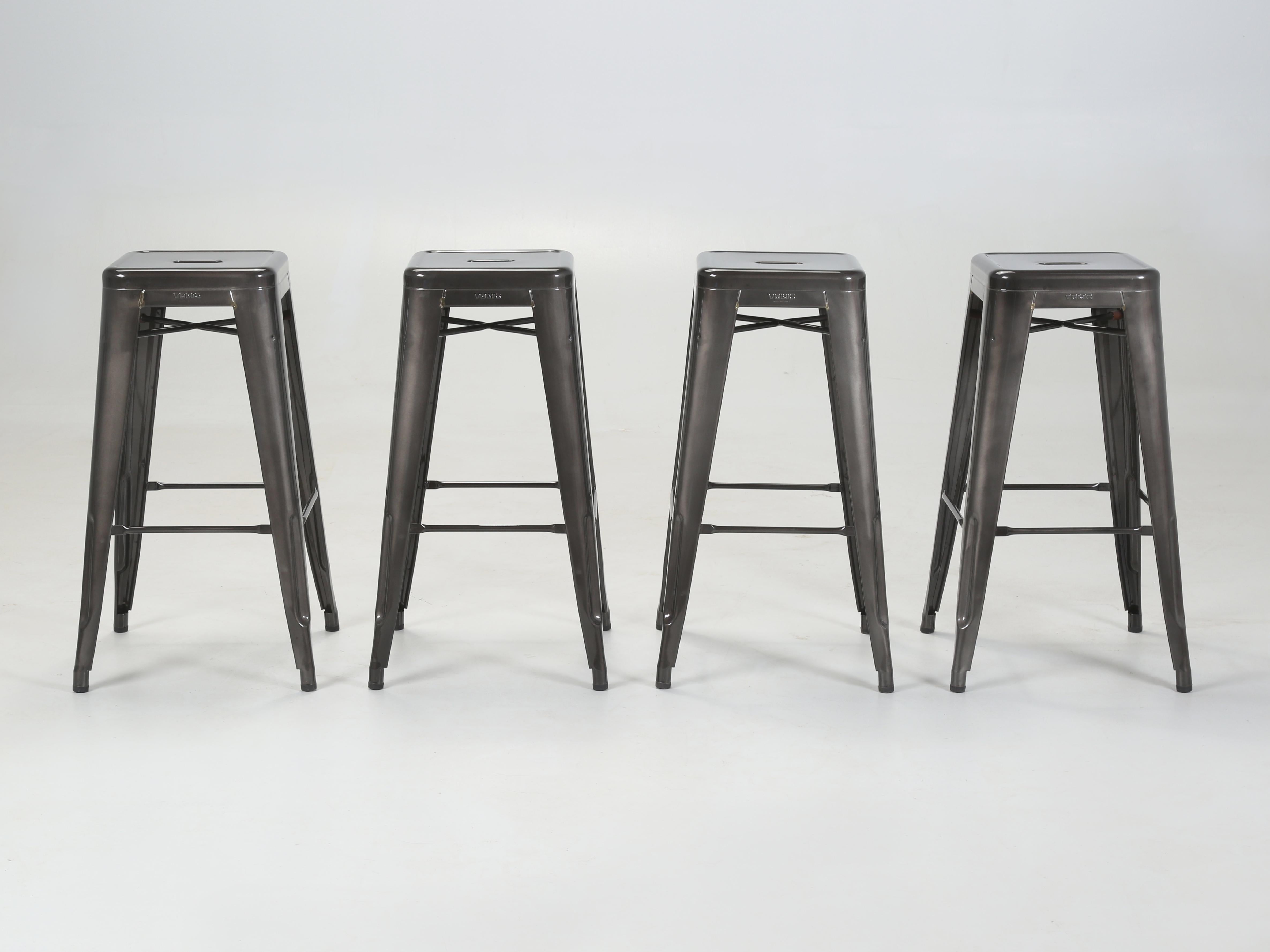 Tolix Genuine Hand-Made in France Set of 4 Bar Height Steel Stools. Our set of 4-Tolix bar Stools were powder-coated in a charcoal grey color and because they have been in a warehouse for over 10-years they will have some minor surface