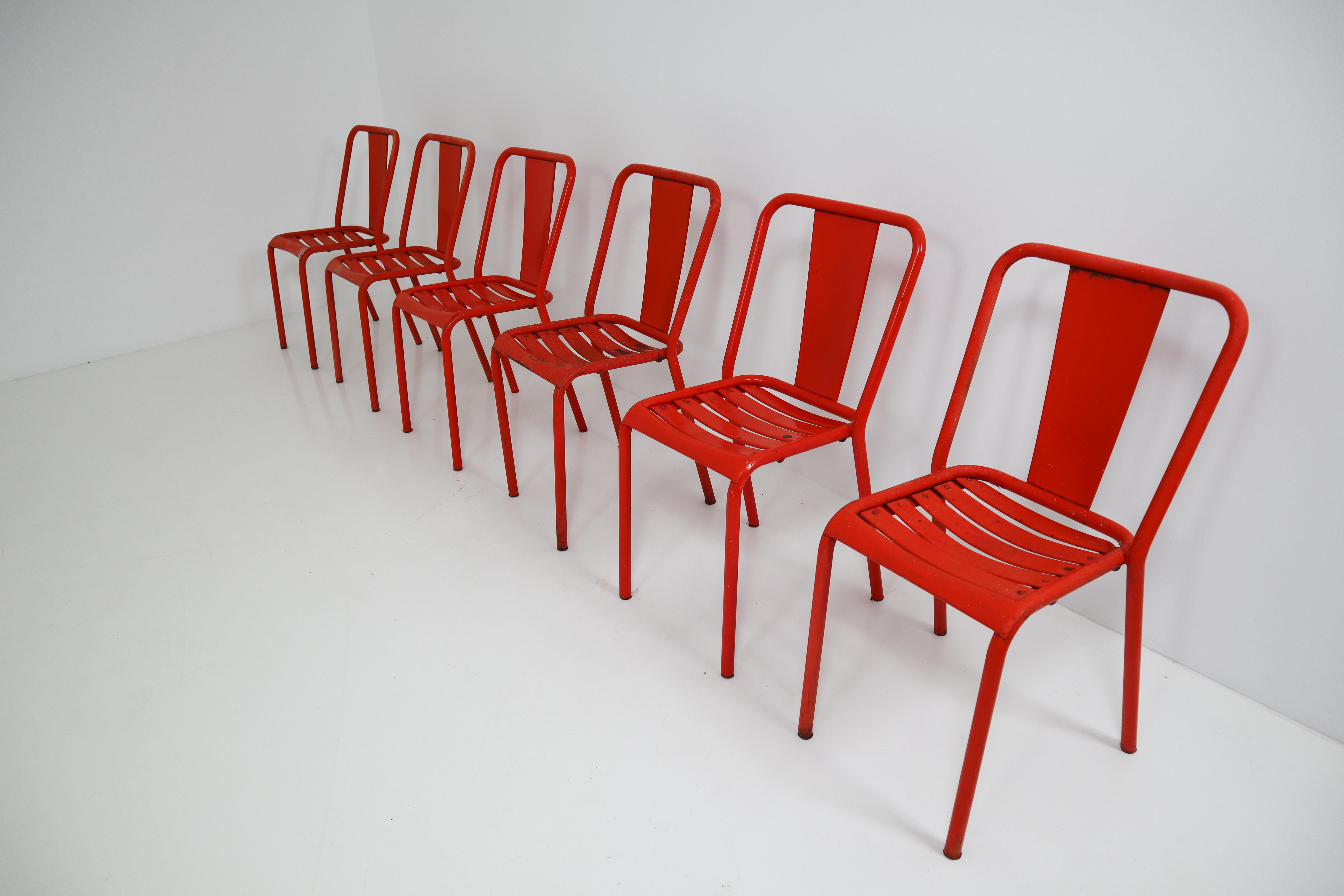 Tolix T4 metal chairs by designer Xavier Pauchard, in Red color. Pretty patina. Probably from 1950, without certainty. Ideal for midcentury, industrial decoration. Measures: Seat height 45cm. 

The French company Tolix was founded after World War