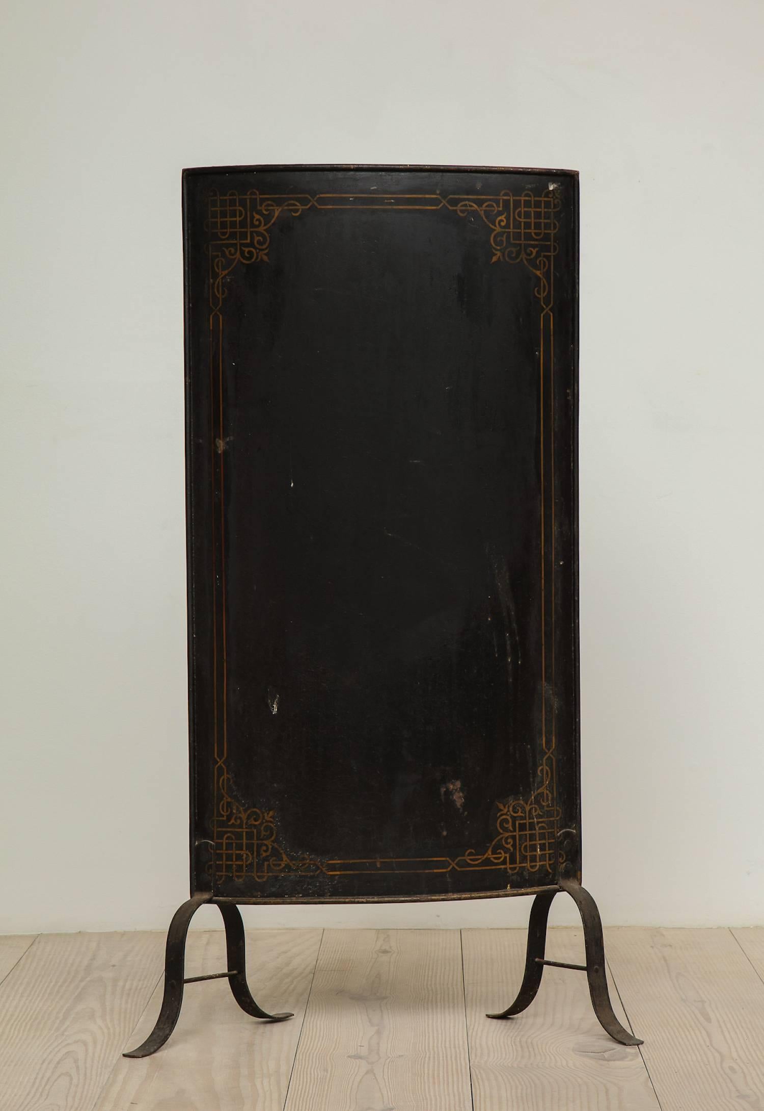 Swedish fire screen, origin: Sweden, circa 1890, painted black metal with gold design border.