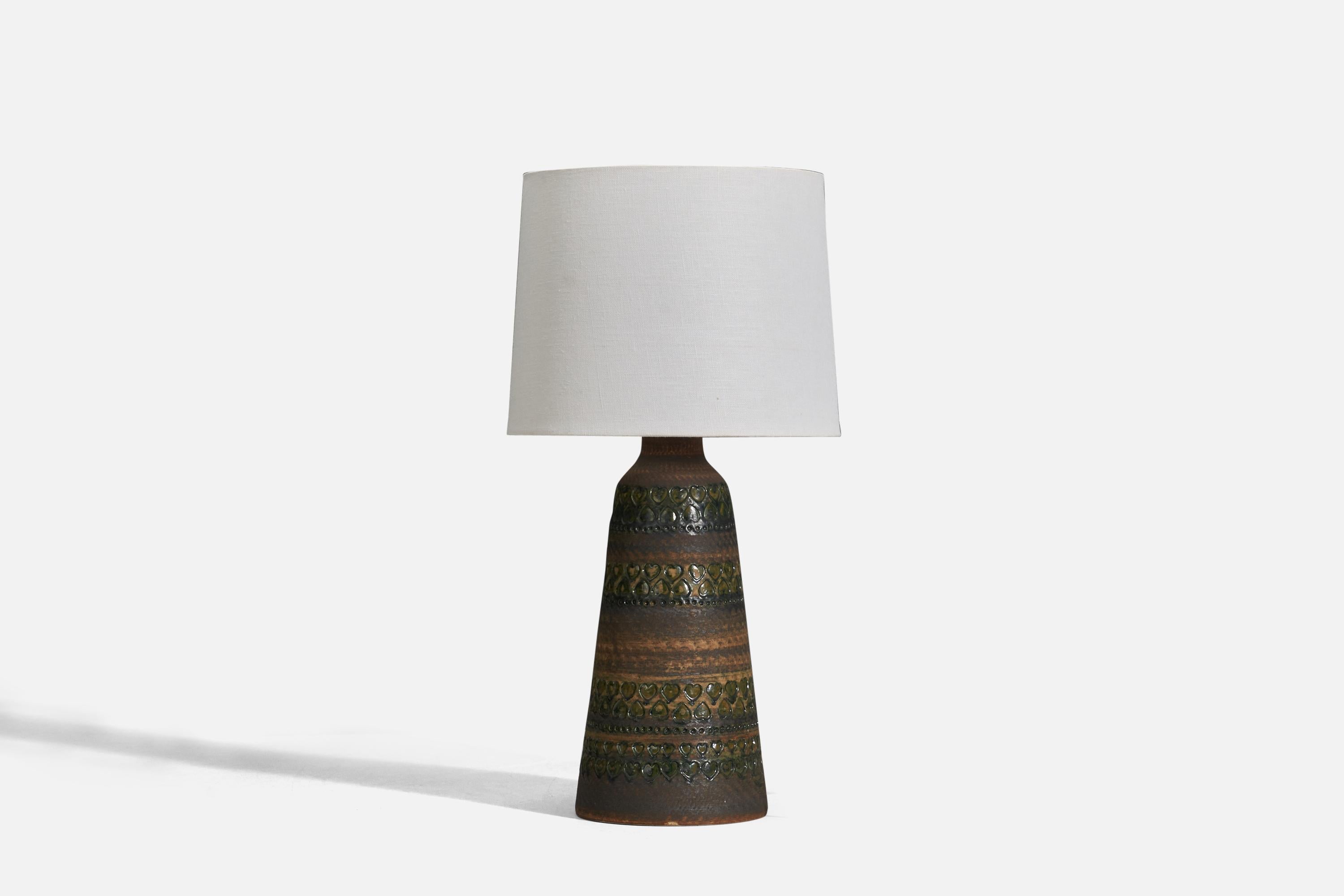 A brown glazed stoneware table lamp designed and produced by Tolla Keramik, Sweden, 1960s.

Sold without Lampshade
Dimensions of Lamp (inches) : 15 x 5.93 x 5.93 (height x width x depth)
Dimensions of Lampshade (inches) : 9 x 10 x 8 (top