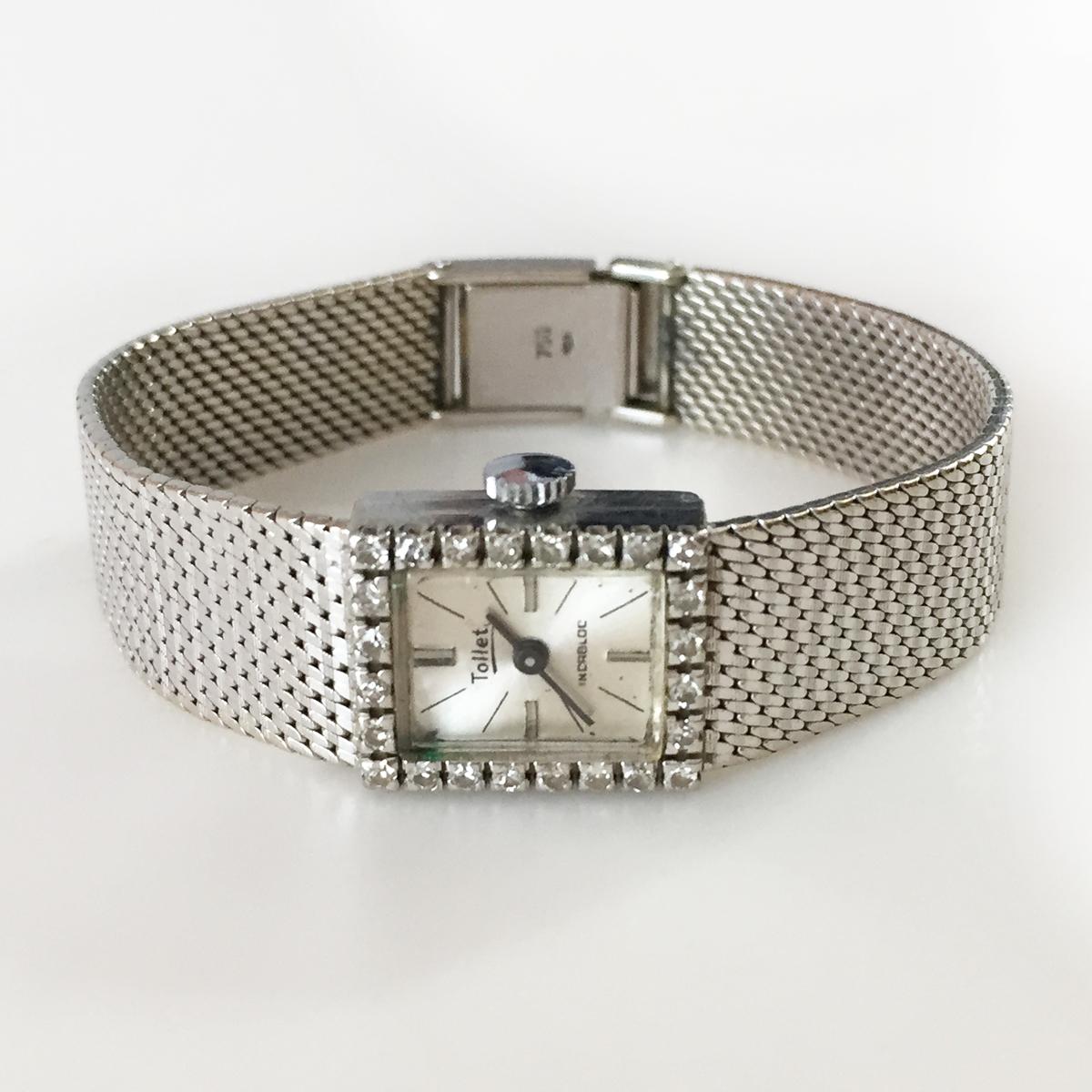 TOLLET: Vintage 18k white gold diamond bezel TOLLET Incablock Swiss made ladies winding movement watch with mesh bracelet. Weight 35.3 grams. Hallmarked 750 (equal to 18k gold). 24 diamonds on rectangular bezel total weight approx. 0.50 ct. Near