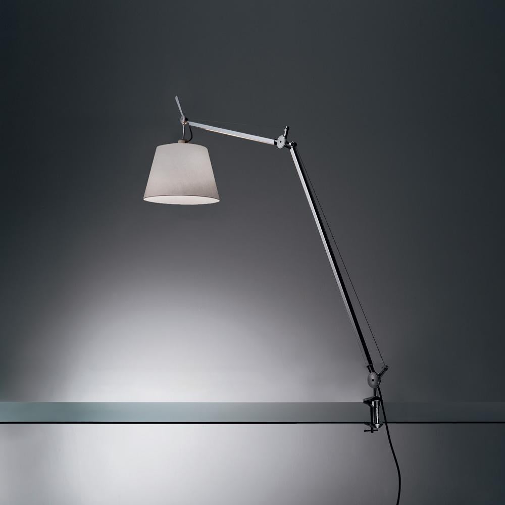 An extension to the iconic Tolomeo family, Tolomeo with shade features the same arm balancing body system as the Tolomeo table lamp combined with a selection of parchment or fabric shades, giving a warmer and more transitional look to the original