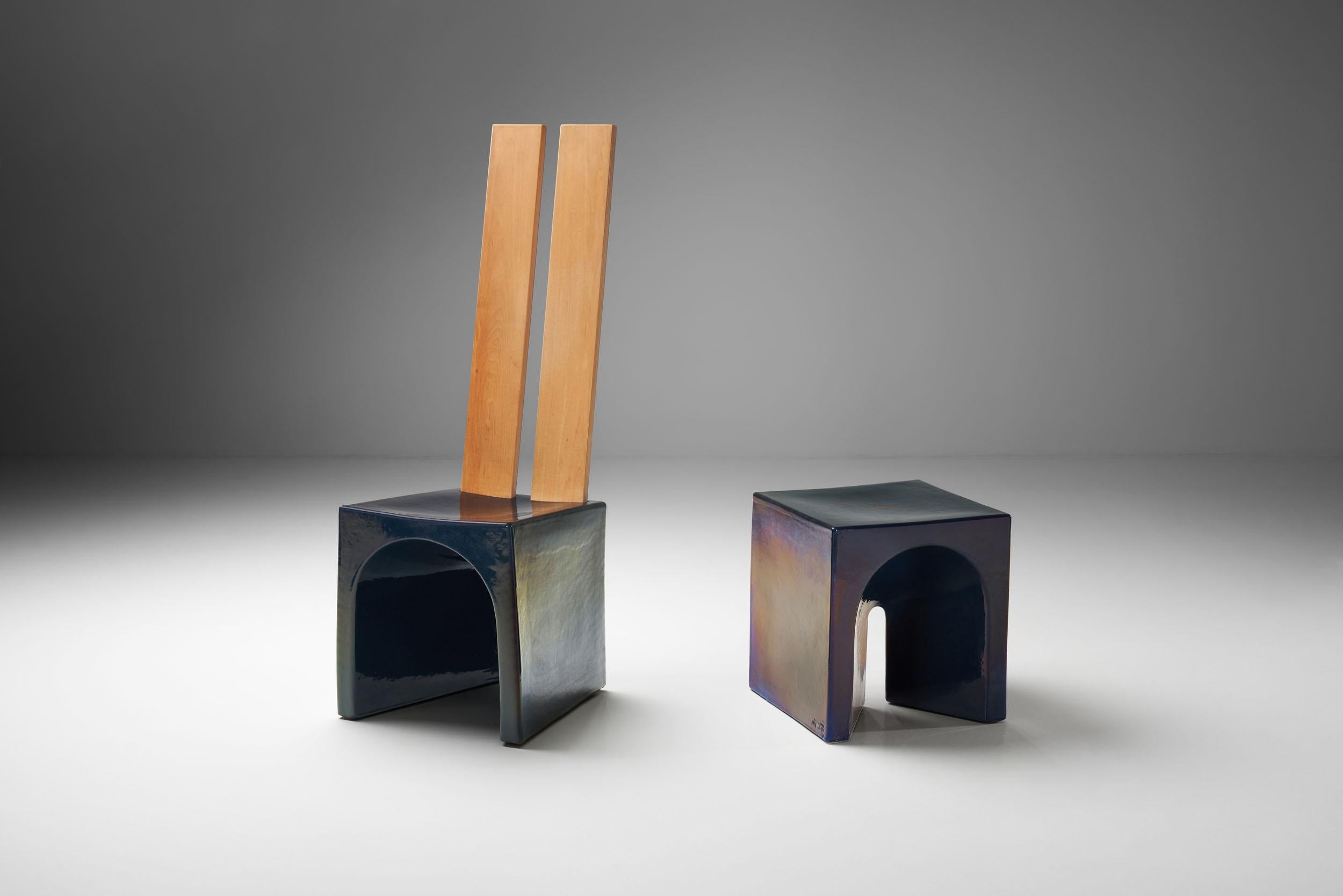 This elemental chair and table are a beautiful example of the collaboration between Dutch designer Tom Bruinsma and Mobach ceramics. These fully glazed ceramic pieces appear in a variety of colors depending on the angle and light. The wooden backs