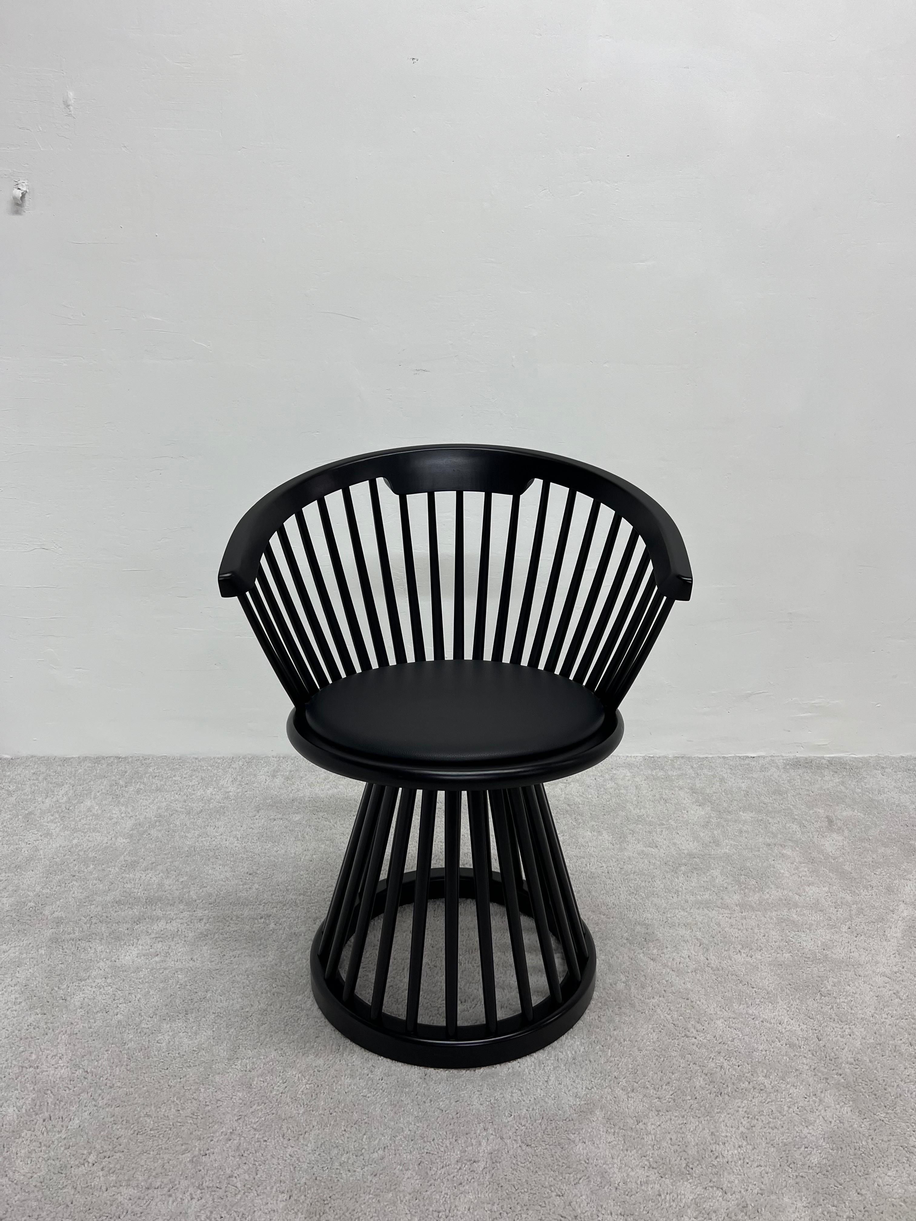 Black stained birch Fan dining chair with a splayed array of machined wood spindles, curved wood back and round base with black leather seat pad. Designed by Tom Dixon.