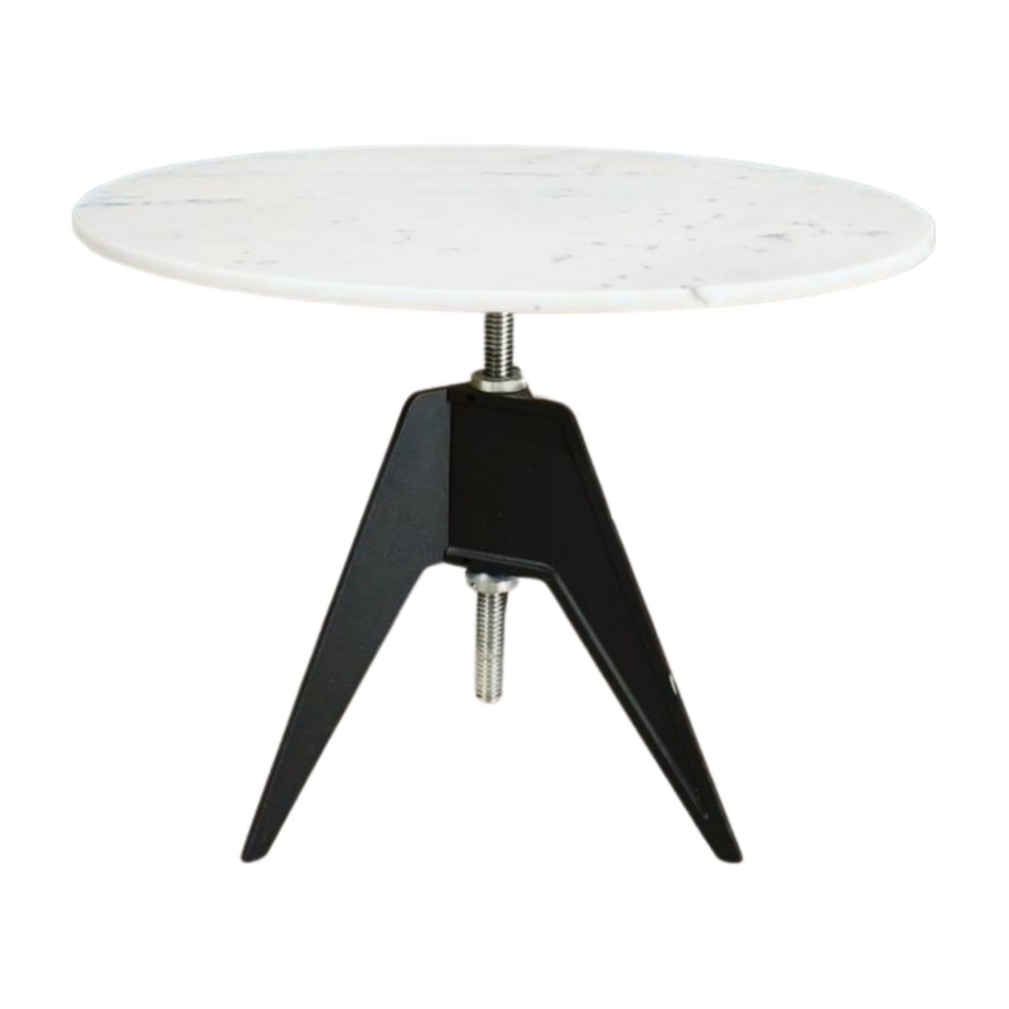 The Screw Marble Table by Tom Dixon, crafted in 2010, features a sleek and modern design with a marble top and metal base. Perfect for contemporary living spaces, adding both style and elegance.