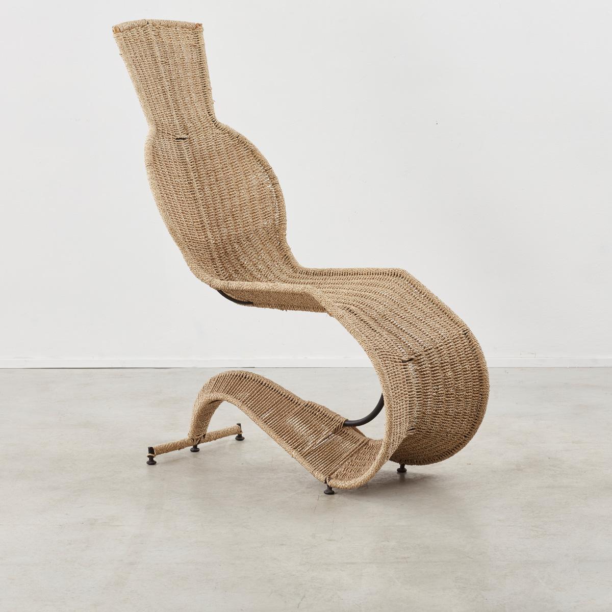 A rare lounge chair by British designer Tom Dixon for Space Design. A delicate braided rope has been systematically woven across its iron frame, a method Dixon employed in various early works. The chair is very comfortable and has a lovely spring to
