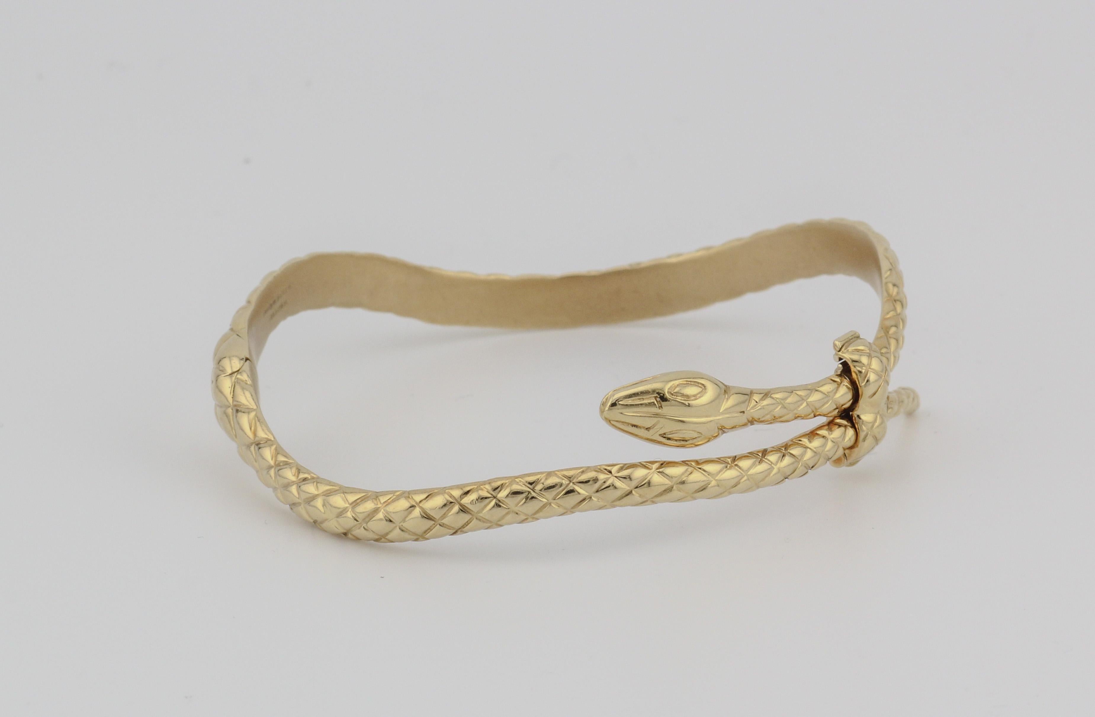 The Tom Ford 18k Yellow Gold Snake Bangle Bracelet is an opulent and striking piece of jewelry that exemplifies sophistication and bold design. This exquisite bracelet is a testament to the renowned fashion designer's commitment to luxurious