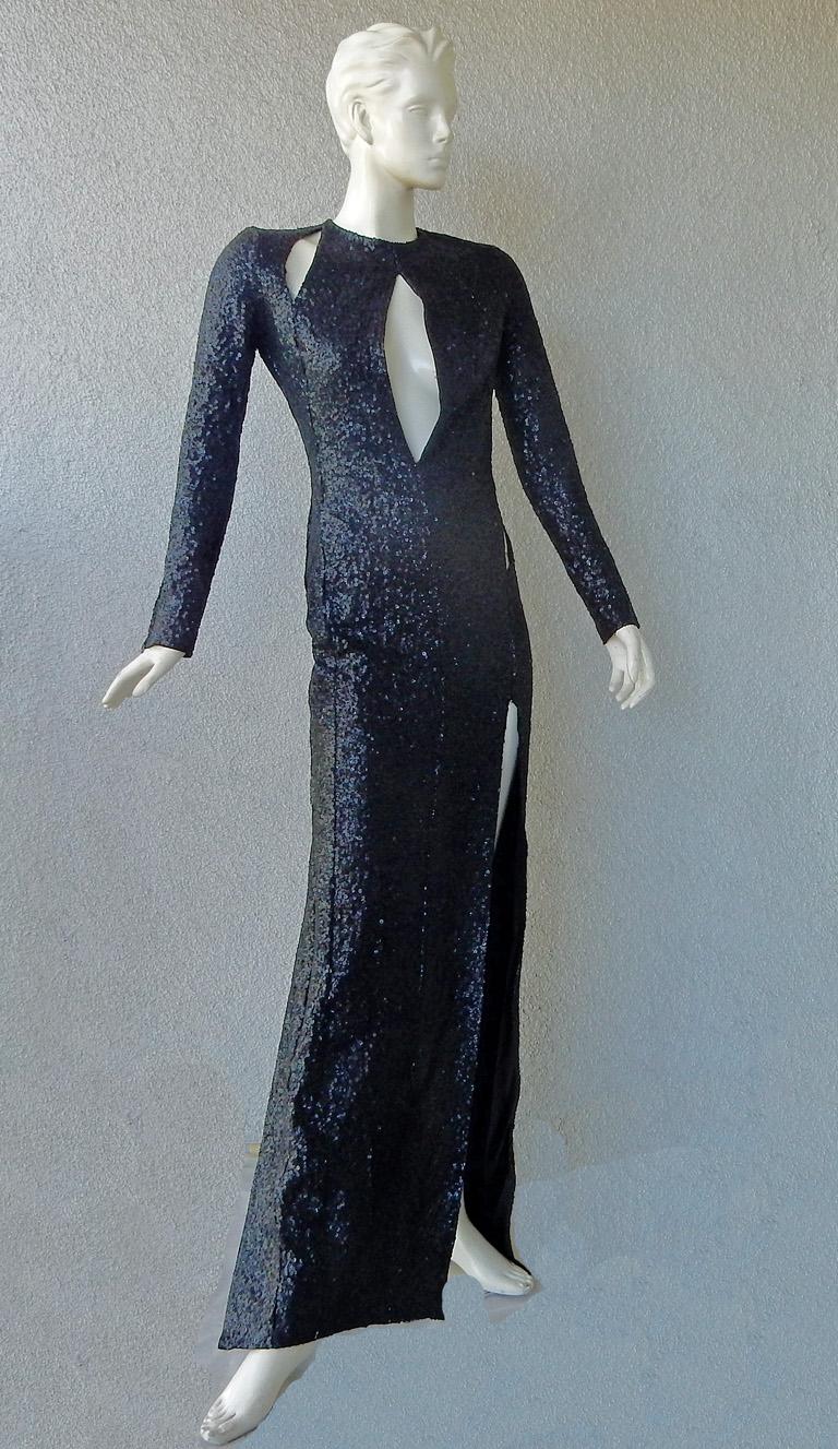  Entrance maker black sequin cut-out gown.   A hi fashion design that will surely get you noticed. 

Long sleeve keyhole front bodice with single side cutout at waist.  Thigh high slits on either side of the dress.
Plunging neckline; concealed zip