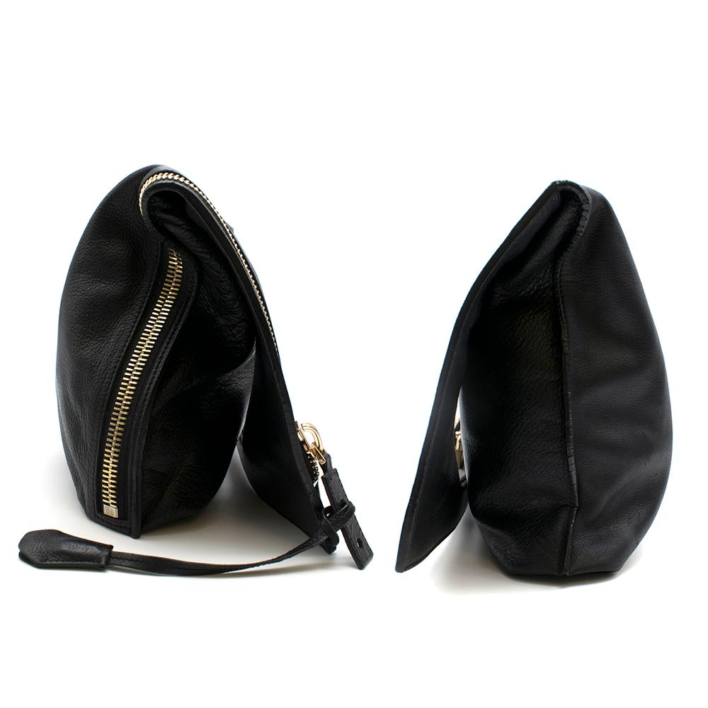 Tom Ford Alix Foldover Flap Bag

Can be worn as a shoulder bag or clutch
Gold hardware lock, key, and zipper
Zipper zips midway down side
Smooth, textured black leather
Mini pouch with strap attached inside

Please note, these items are pre-owned