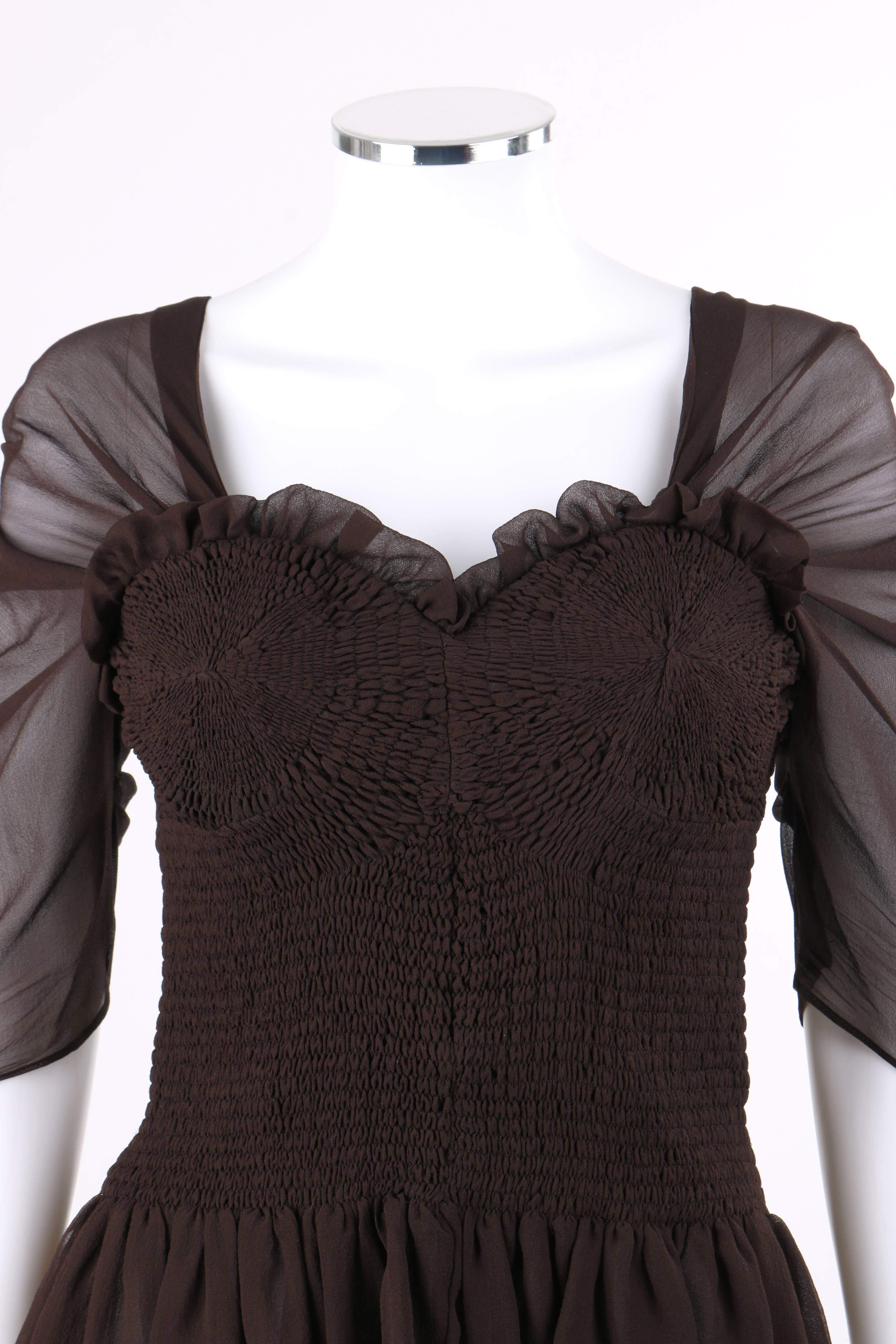 Tom Ford Autumn/Winter 2015 brown silk georgette smocked corset peplum top. Sweetheart neckline with ruffled detail along front edge. 3/4 length semi-sheer sleeves with knife pleat detail. Smocked bodice with semi-sheer gathered panel at back. Low