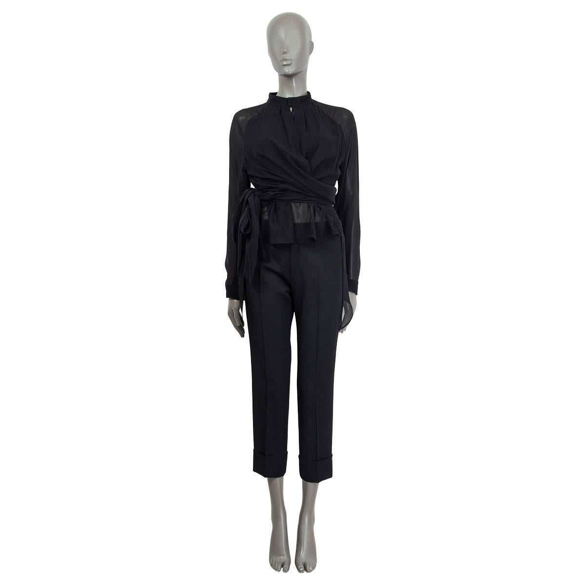 100% authentic Tom Ford knotted blouse in black silk-georgette (100%). Features buttoned cuffs, long raglan sleeves (sleeve measurements taken from the neck) and an asymmetric hem. Opens with three buttons and self-tie knot on the front. Lined in