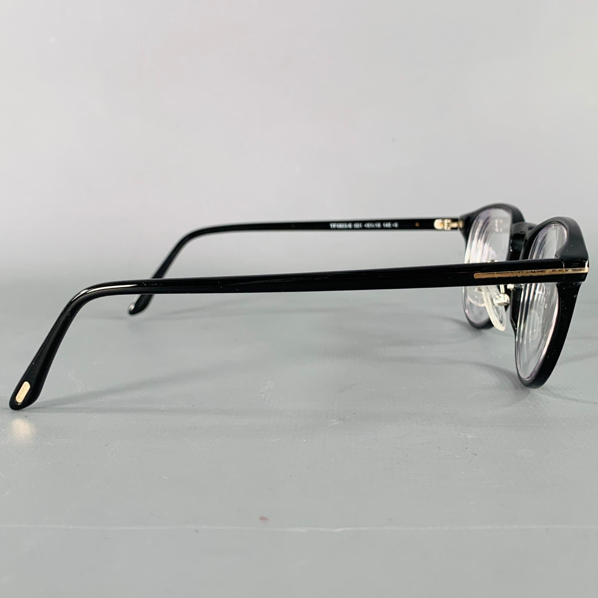 TOM FORD frames
in a
black acetate featuring a round shape and metal monogram temple accents. Comes with case. Made in Italy. Note: these frames contain corrective lenses, which will need to be changed by an optician before wear.Excellent Pre-Owned