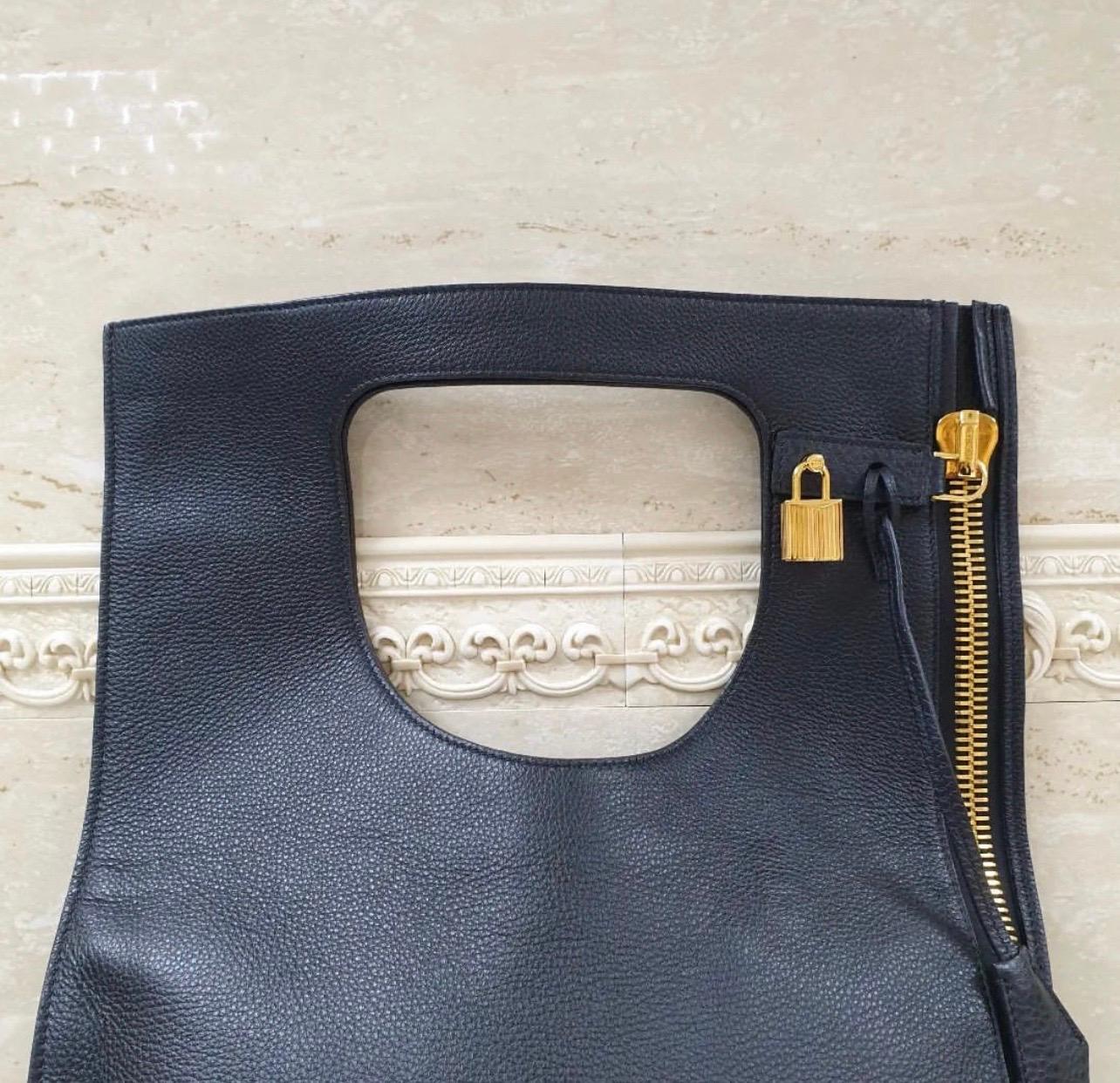 
TOM FORD Alix Leather Padlock & Zip Shoulder Bag

    Kidskin with golden hardware.
    Can be carried with cutout top handle over the shoulder or folded over and held in hand.
    Padlock, key, and zip pouch attach to vertical side zip.
    22