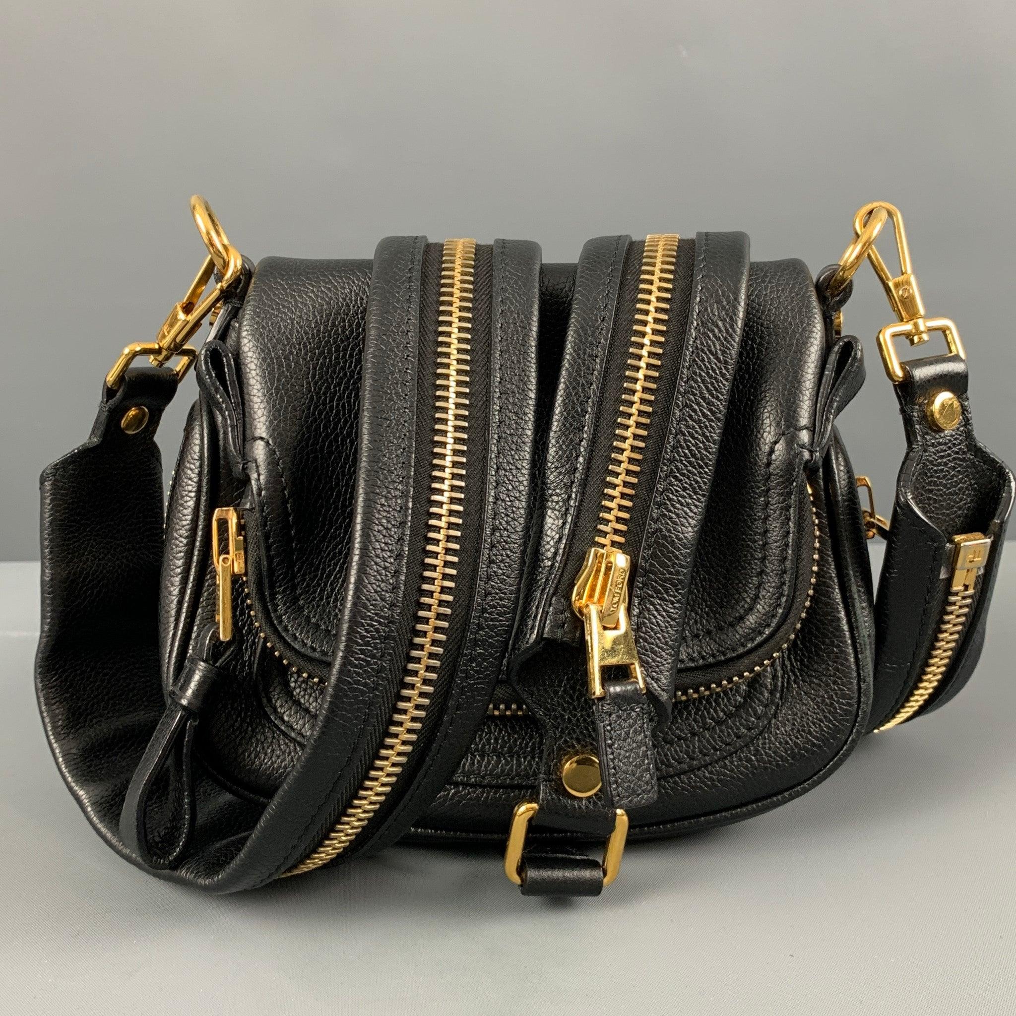 TOM FORD JENNIFER double paunch handbag comes in a black leather featuring a shoulder strap, gold tone hardware, inner pocket, and a zipper closure. Made in Italy.Very Good Pre-Owned Condition. Minor signs of wear. 

Marked:   L0313t-010-AE