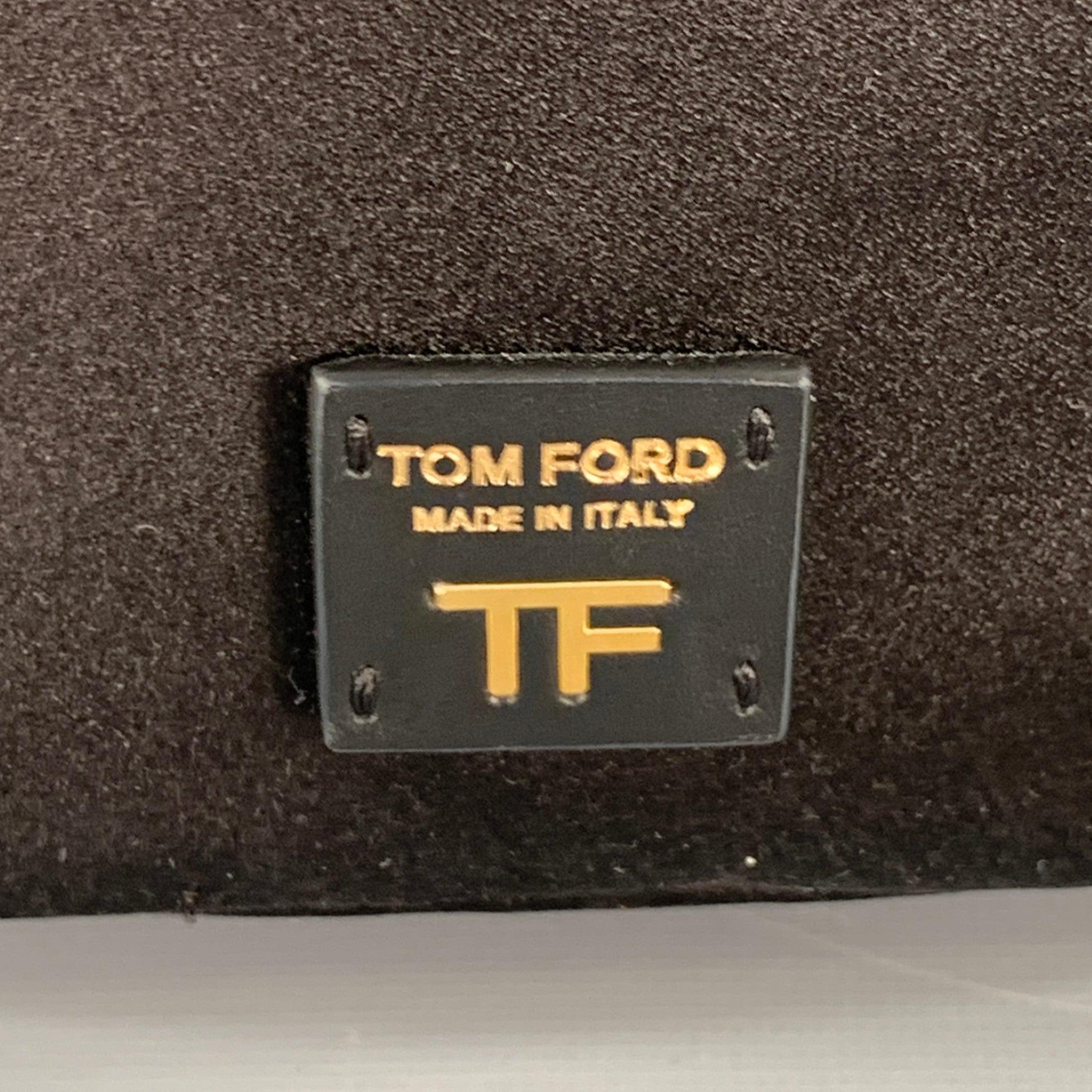 TOM FORD handbag
in a black satin featuring a bucket style, gold tone metal chain strap, and black leather drawstring closure. Comes with dust bag. Made in Italy.Very Good Pre-Owned Condition. Minor signs of wear. 

Measurements: 
  Length: 6.5