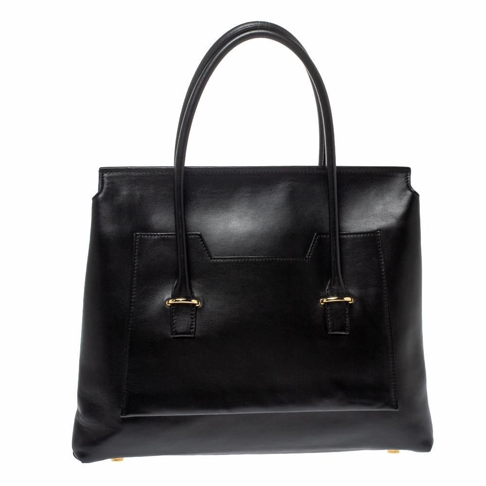 You will enjoy parading this Icon bag from Tom Ford. It comes made from black leather and features two rolled handles on top. It is equipped with gold-tone hardware and a suede-lined interior meant to hold all your daily essentials with