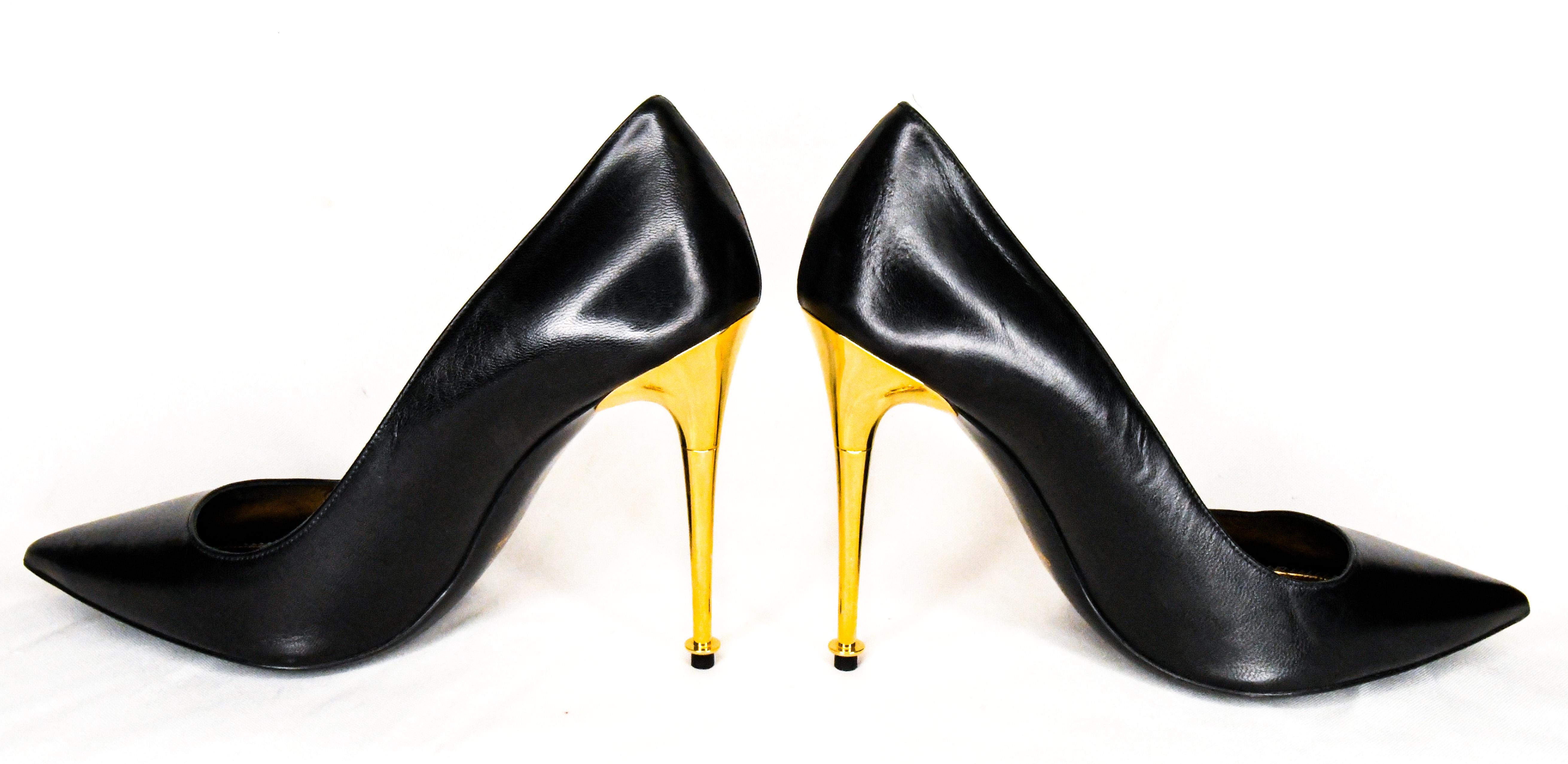Tom Ford Black Leather Pumps are classic in every way.  Features exquisite black leather uppers, pointed toes and eye-turning gold tone metal stiletto heels.  Metallic gold leather insoles finish this undeniably seductive shoe.  Excellent Condition.