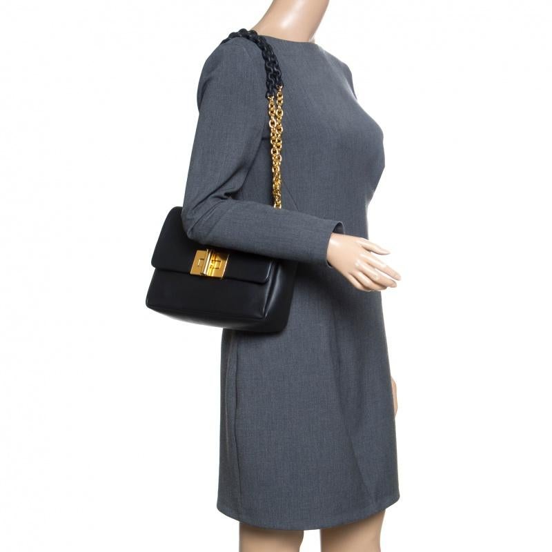 This Natalia shoulder bag from Tom Ford is here to end all your fashion woes, as it is striking in appeal and utterly high on style. It has been crafted from leather and designed with a flap that has a gold-tone turn lock. The insides are lined with