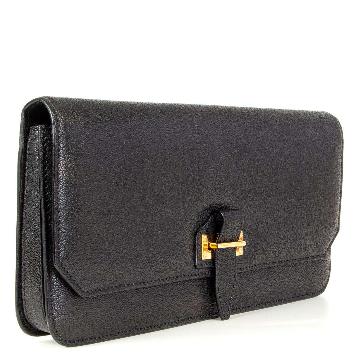 Tom Ford clutch in black grained calfskin with gold-tone metal luck. Divided in three compartements and lined in black microfibre. Has been carried and is in excellent condition. 

Height 15cm (5.9in)
Width 30cm (11.7in)
Depth 3cm (1.2in)
