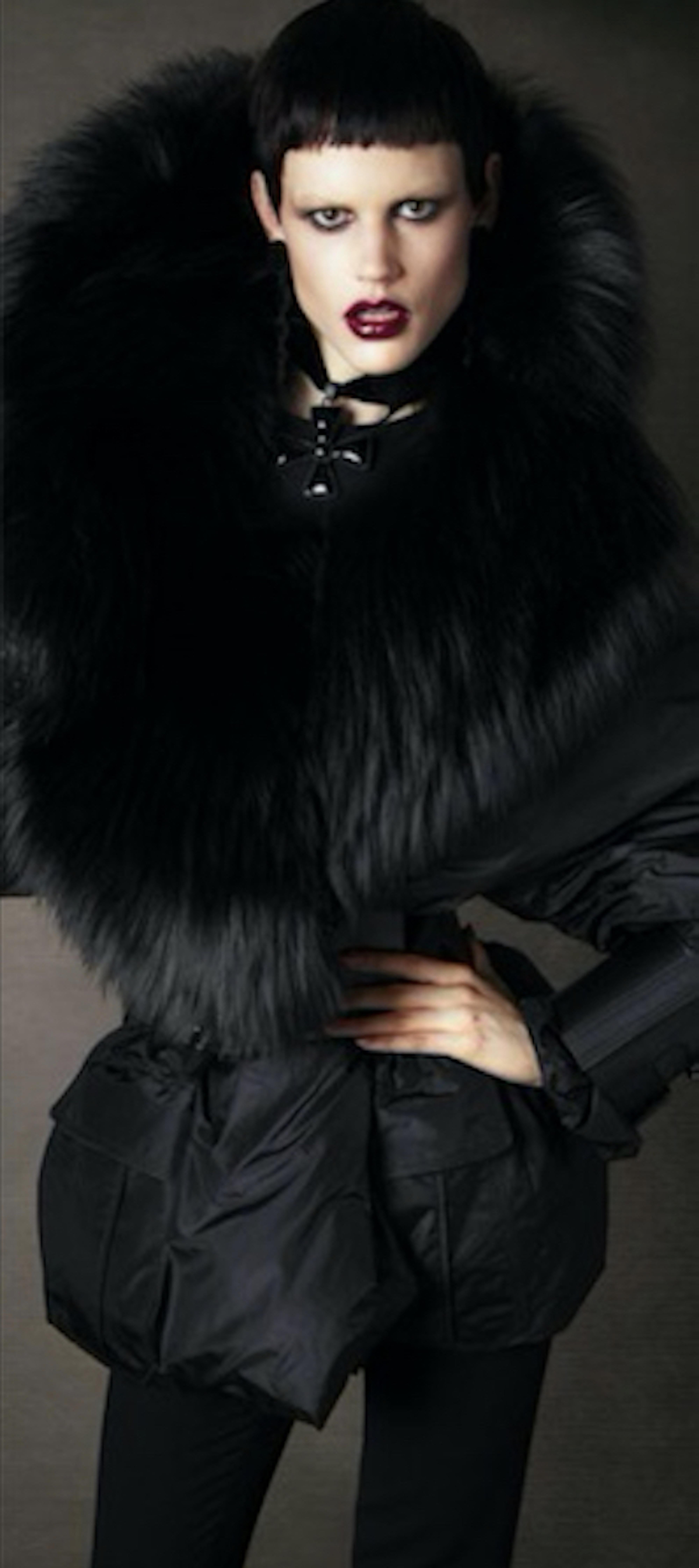 Tom Ford 

- Black nylon Puffer coat and fur trim with belt
- Dramatic buckle detailing on the sleeves and waist 
- Real fur and real leather cuffs and belt 
- Fall 2011  collection
- Italian size 38  
