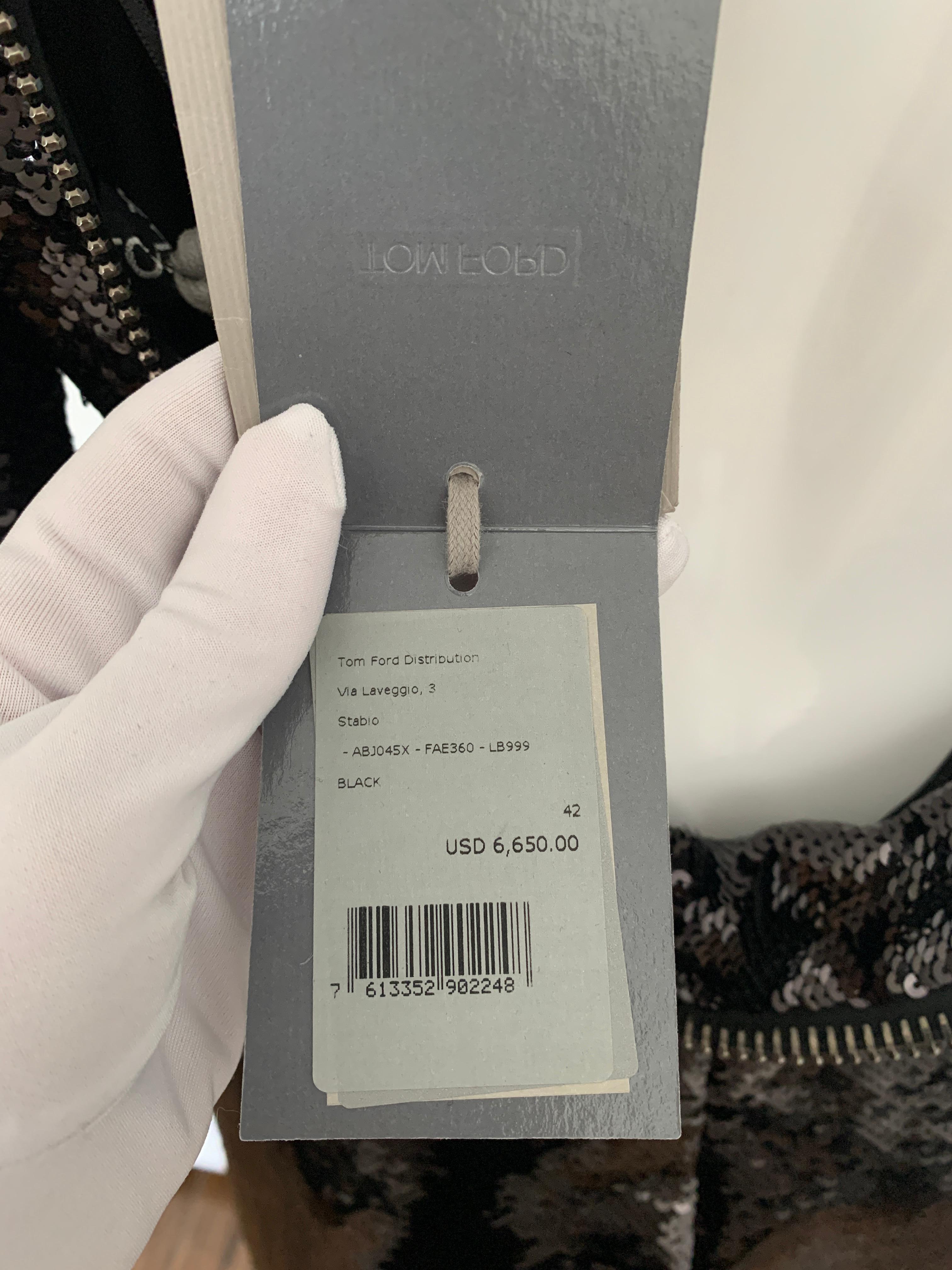 Tom Ford Black, Signature, Open Back, Zip Liquid Sequin Dress with tags still attached. 

Size 42

Please see the description below from Tom Ford site: 

A SIGNATURE TOM FORD GUNMETAL ZIP CREATES AN ALLURING OPEN-BACK DRESS WITH A HIGH NECKLINE.