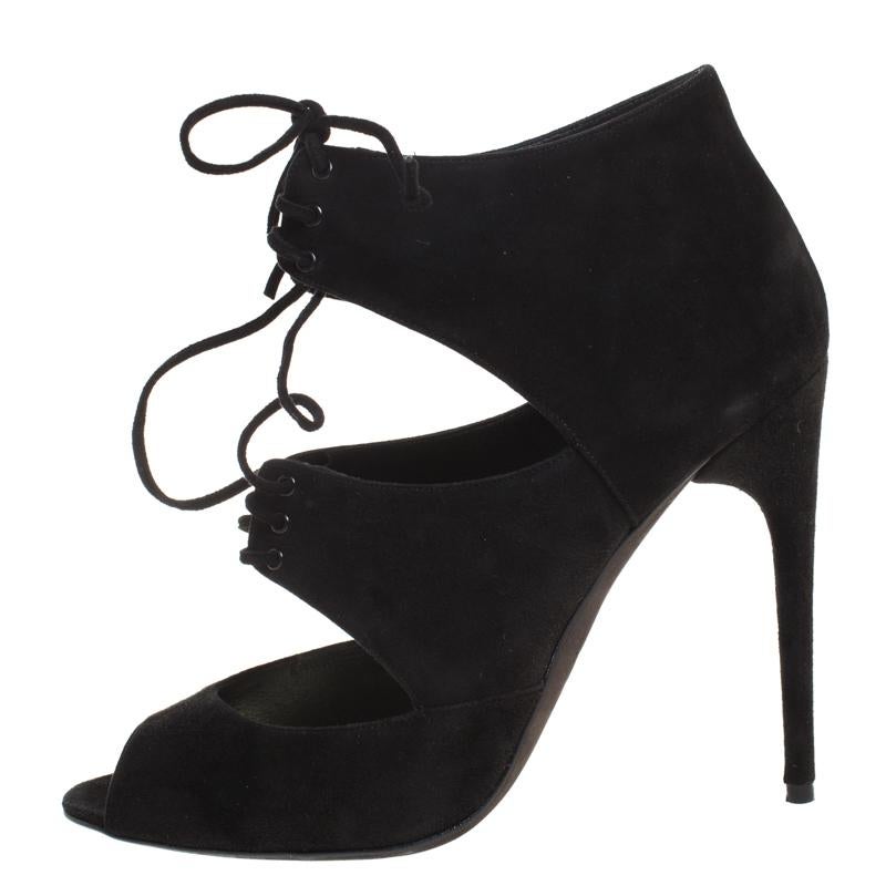 Never go out of style with this classy pair of booties from the house of Tom Ford. Crafted in Italy, they have been made from quality suede. They come in a classic shade of black and feature an elegant silhouette. They are styled with open toes,