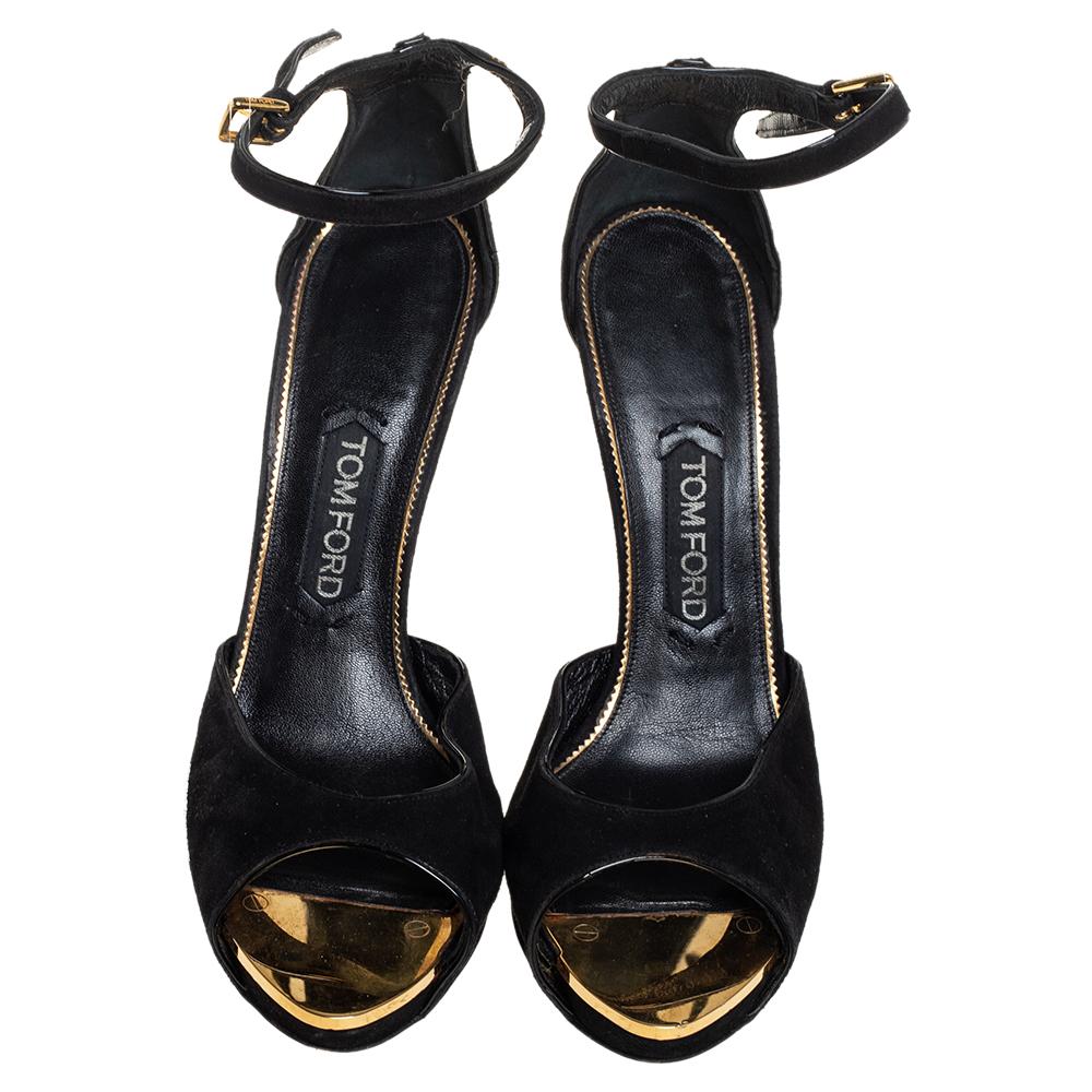 Tom Ford made these sandals to crown your feet with beauty. They are constructed using black leather and detailed with screws on the counters and heels. Buckle fastening and high heels make the pair ready to be worn and flaunted.

