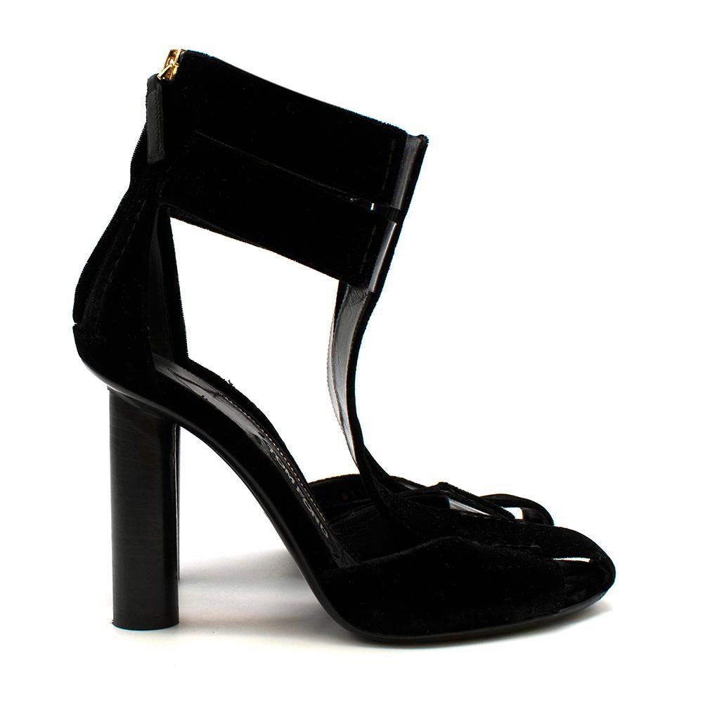 Tom Ford Black Velvet T-Strap Chunky-Heel Sandal

- See Through Cut-Outs
- Back Zip Fastening 
- Almond Toe
- Thick Round Black Heel 
- Gold Hardware And Insole Trimming 
- Leather Insole

Material:
- 100% Leather 

Made in Italy 

Heel Height: