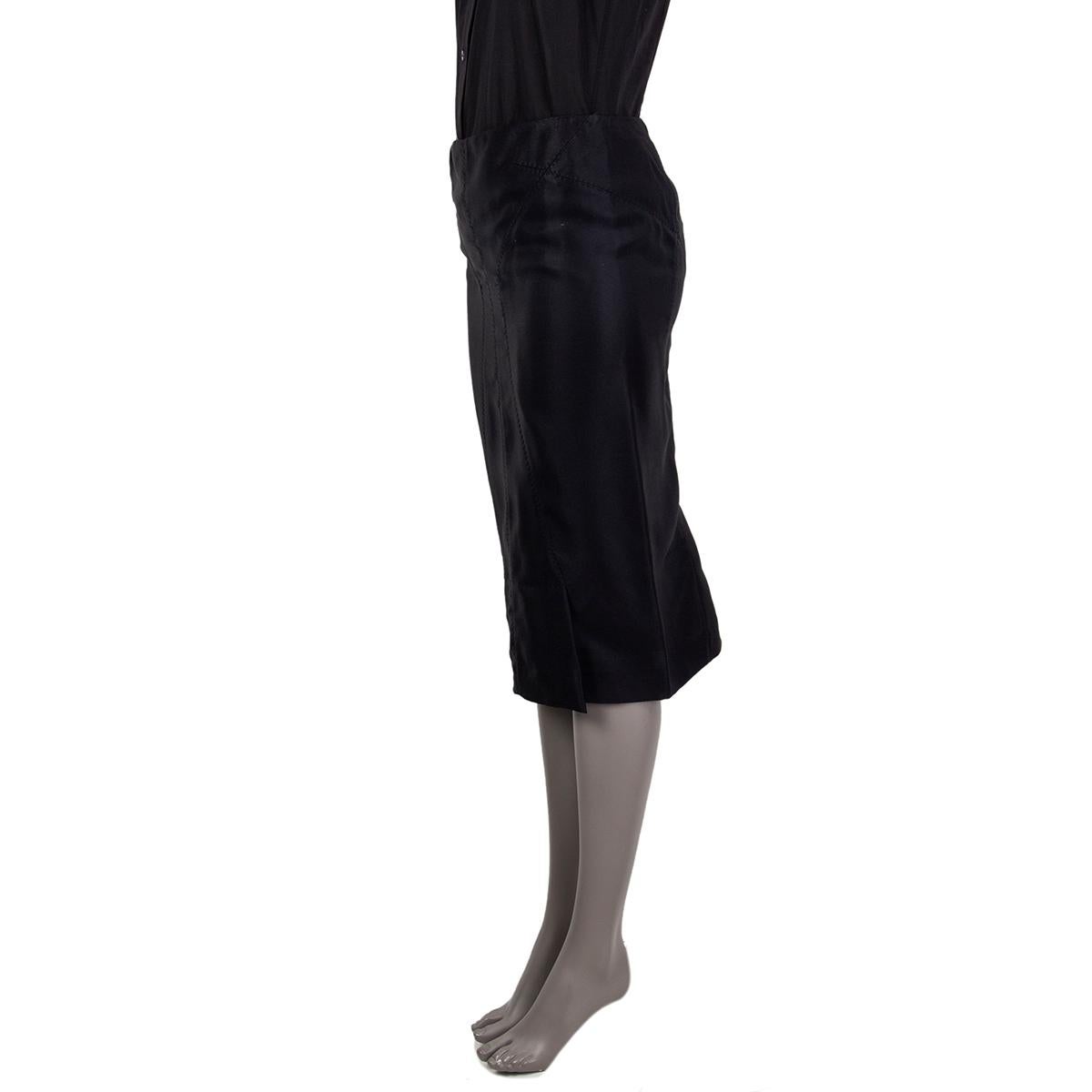 Tom Ford structured pencil skirt in black viscose blend (Missing Tag) and lined in black silk featuring two pleats at front and back. Slit pocket at the back. Opens with a zipper on the back. Has been worn and is in excellent condition. 

Tag Size