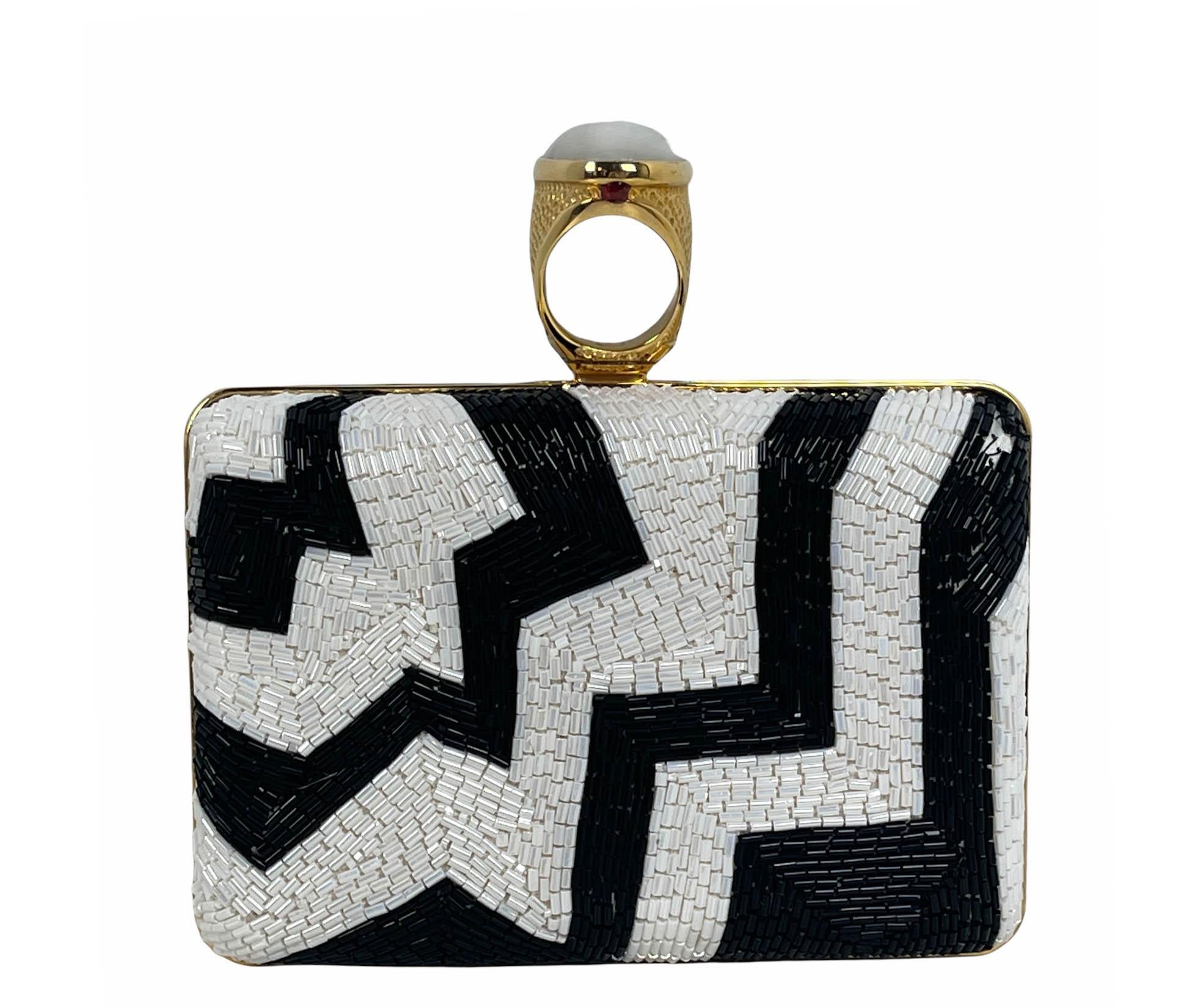 Tom Ford Black & White Beaded Ring Clutch Bag

Made In: Italy
Color: Black and white
Hardware: Goldtone
Materials: Beaded with hammered oval cabochon ring clasp
Lining: Black alcantara
Closure/Opening: Frame
Exterior Pockets: None
Interior Pockets: