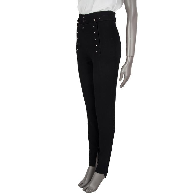 100% authentic Tom Ford high-waist stirrup pants in black virgin wool (98%) and spandex (2%) with a zipper on each cuff, circle embroideries, and a stud-buttoned welt pocket on the back. Close with stud-buttons on the front. Partly lined in black