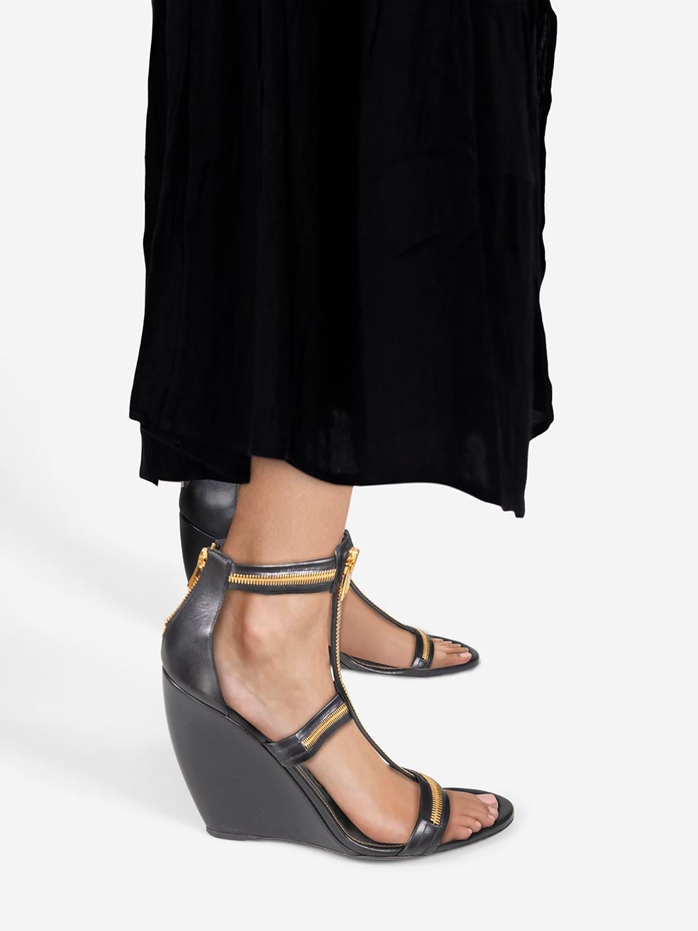 CONDITION is Never worn. Due to poor storage of the the sandals, there is abrasion on both wedges on this new Tom Ford designer resale item.
 
 
 
 Details
 
 
 Black
 
 Leather
 
 Sandals
 
 High wedge heel
 
 Gold zip fastening
 
 
 

 
 Made in