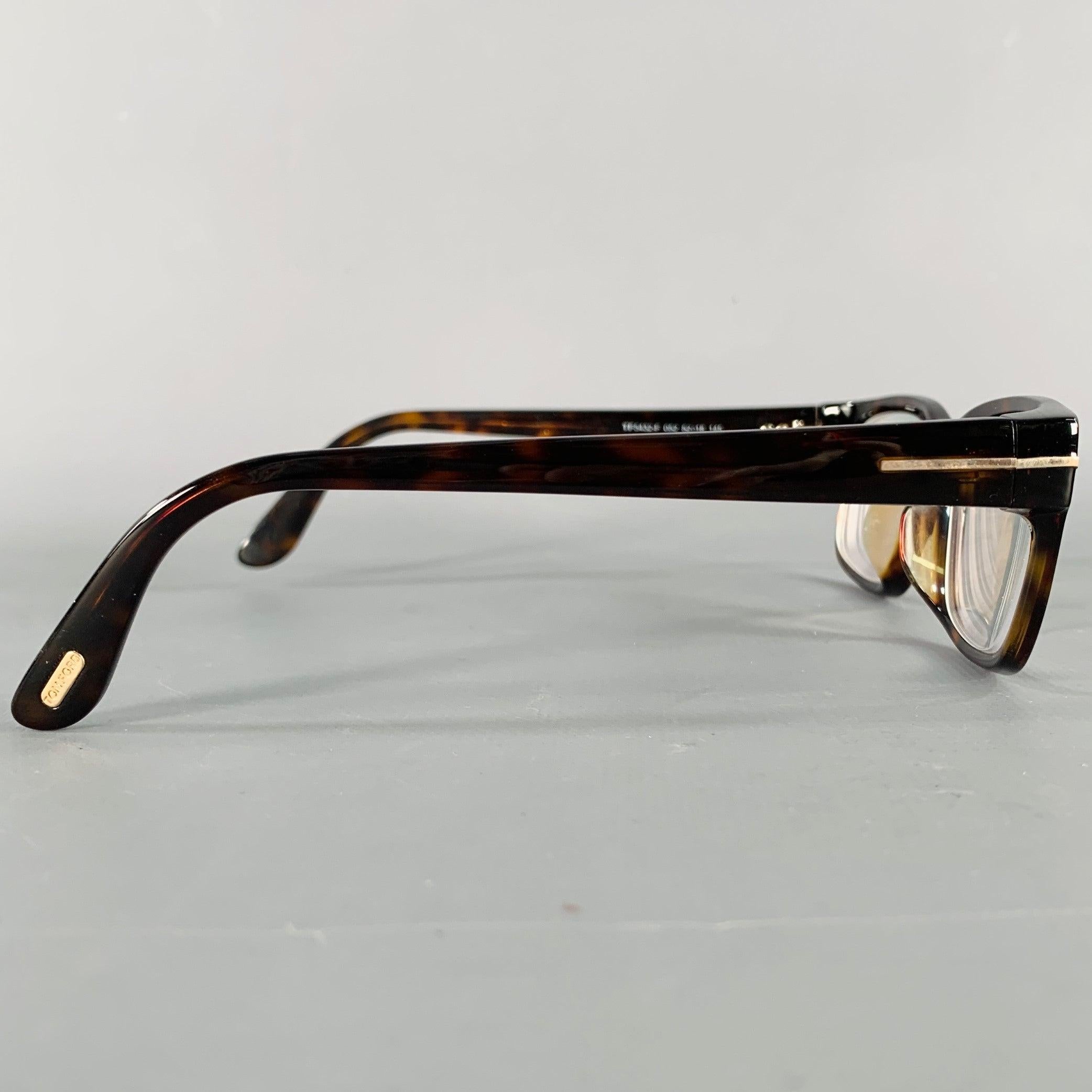 TOM FORD frames
in a brown and beige acetate featuring a tortoiseshell pattern and rectangle shape. Comes with case. Made in Italy. Note: these frames contain corrective lenses, which will need to be changed by an optician before wear.Excellent