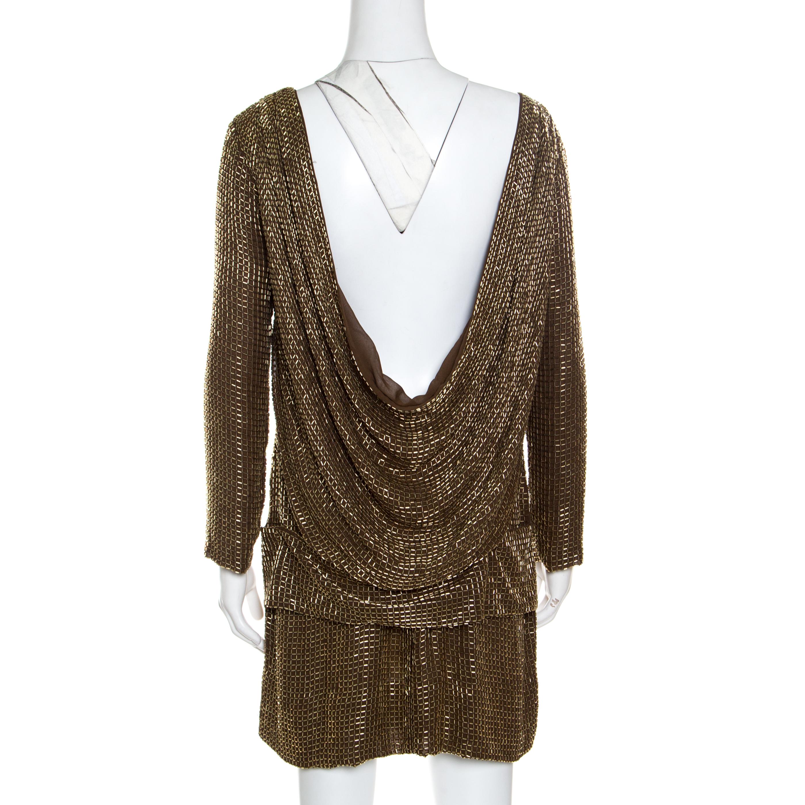 Prep for a glitzy event in this sensational Tom Ford dress. It is well-made and simply stunning to look at which in turn guarantees that it will look great on you. It is covered in beads and designed with long sleeves and an open draped