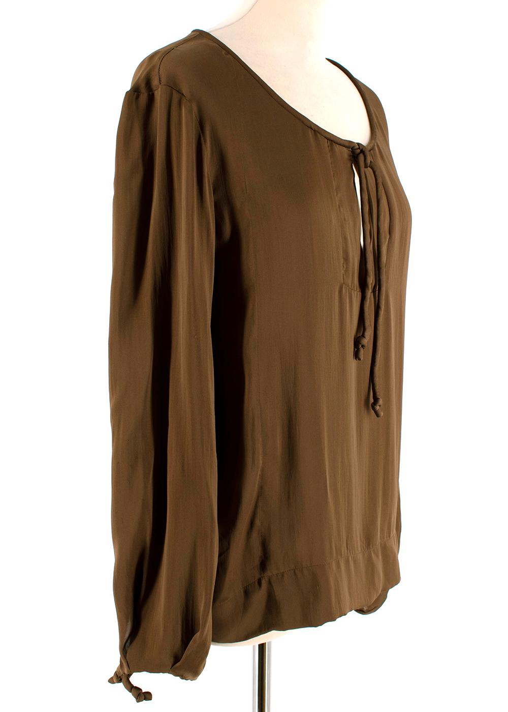 Tom Ford Brown Silk Blouse 

- Tie at neck & sleeves 
- Pleat on back of neck
- Loose Fit 

Materials:
- 100% Silk

Dry Clean only 

Made in Italy 

Measurements are taken laying flat, seam to seam. 

Shoulders - 10cm
Sleeves - 55cm
Chest -