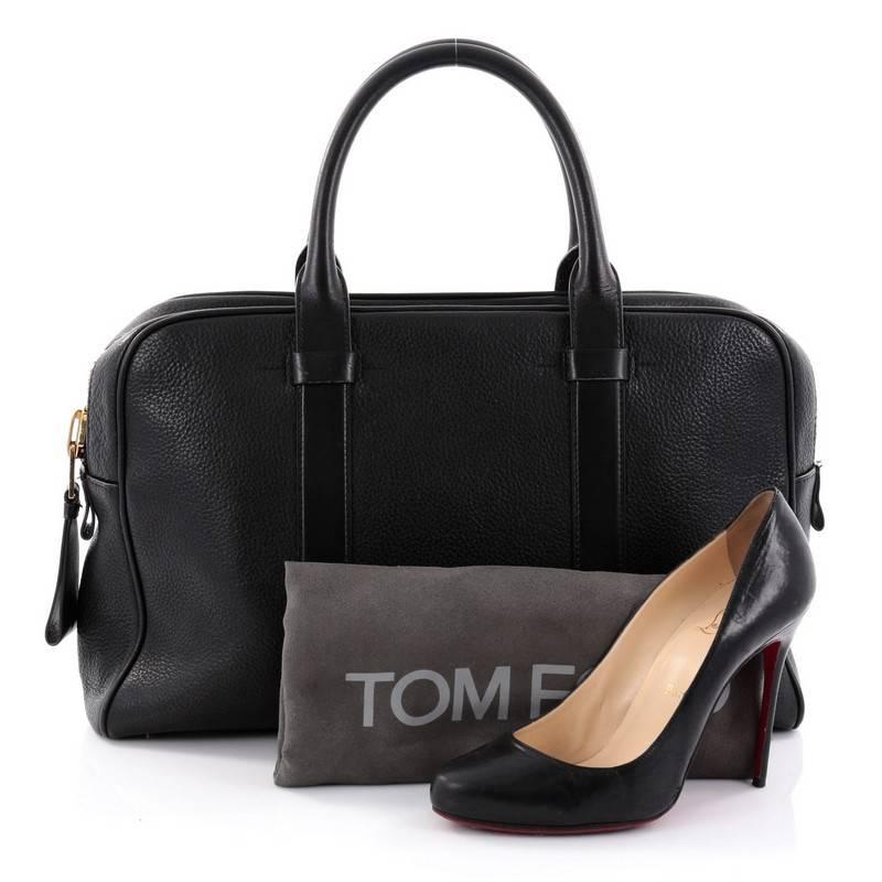 This authentic Tom Ford Buckley Trapeze Briefcase Leather XL is a classic briefcase perfect for daily or business excursions. Crafted in black leather, this stylish and functional carry-all features dual-rolled leather handles, protective base studs