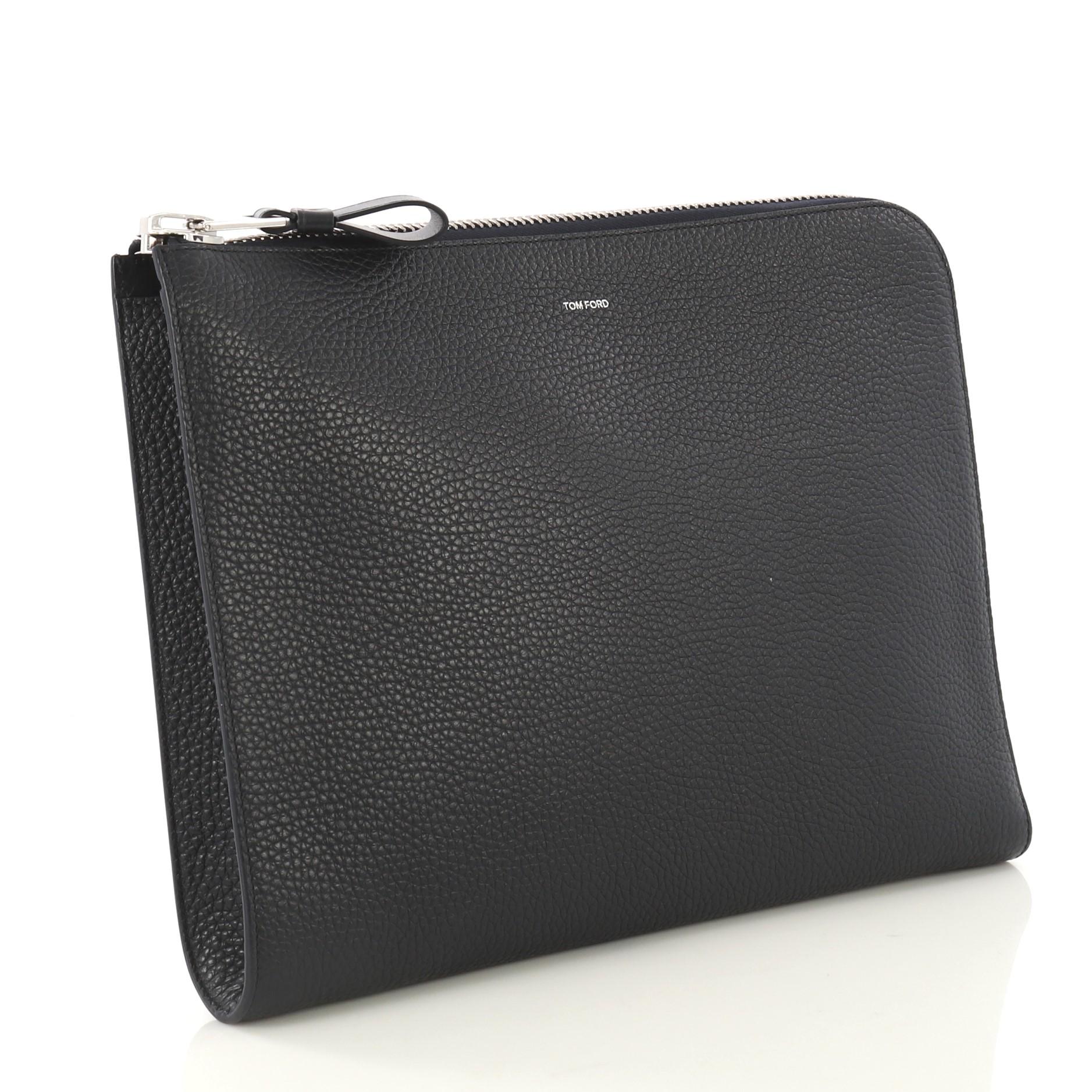 This Tom Ford Buckley Zip Portfolio Leather Medium, crafted from navy blue leather, features silver-tone hardware. Its zip closure opens to a blue leather and black fabric interior with slip pockets. 

Estimated Retail Price: $1,190
Condition: