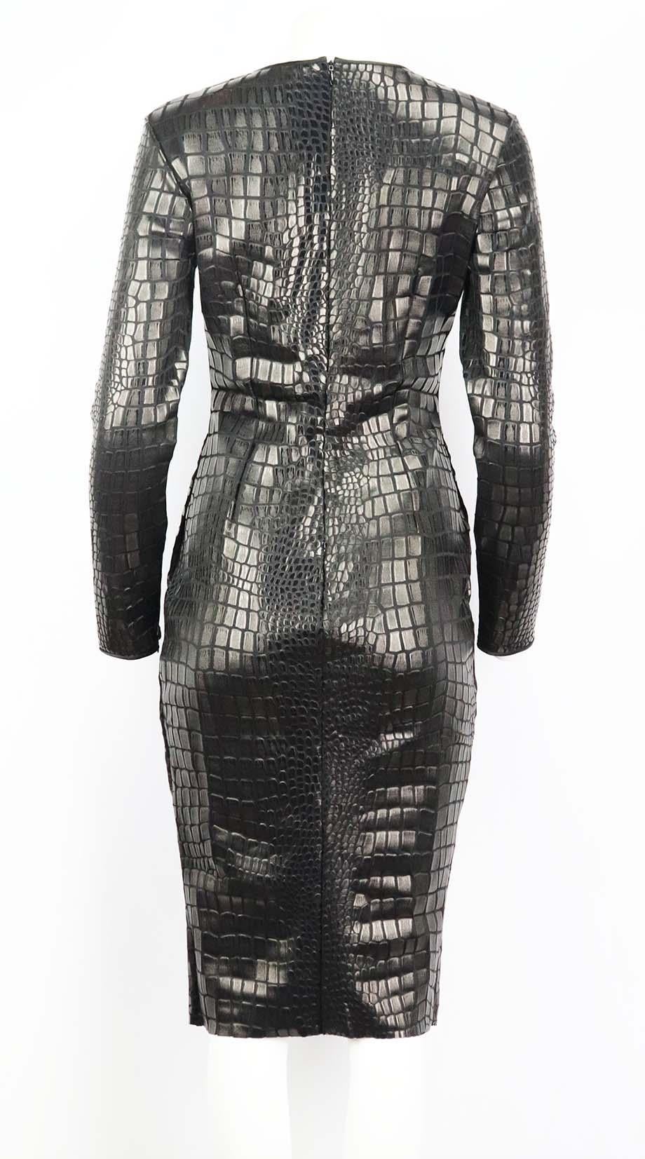 This dress by TOM FORD is made in Italy from black jersey, this style is lacquered with a tonal croc-effect pattern and has a fitted silhouette that falls just below the knee. Black viscose-blend. Concealed zip fastening at back. 96% Viscose, 4%