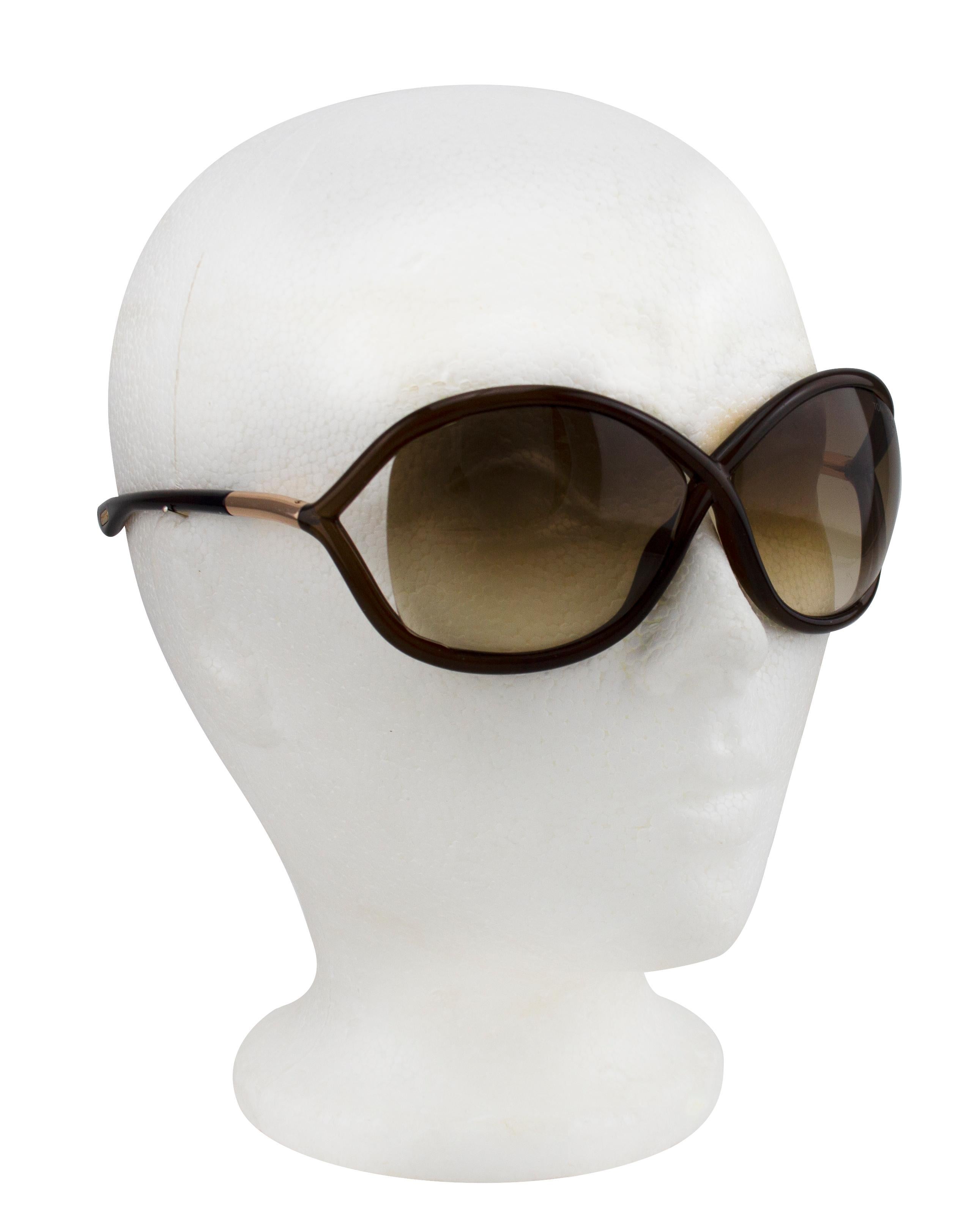 The iconic Tom Ford dark brown Whitney sunglasses. Round acetate frame with brown gradient lenses. Logo etched at top left corner of left side when wearing. Integrated nose pads. Silver metal detail at temples and logo engraved at temple tips. Sold