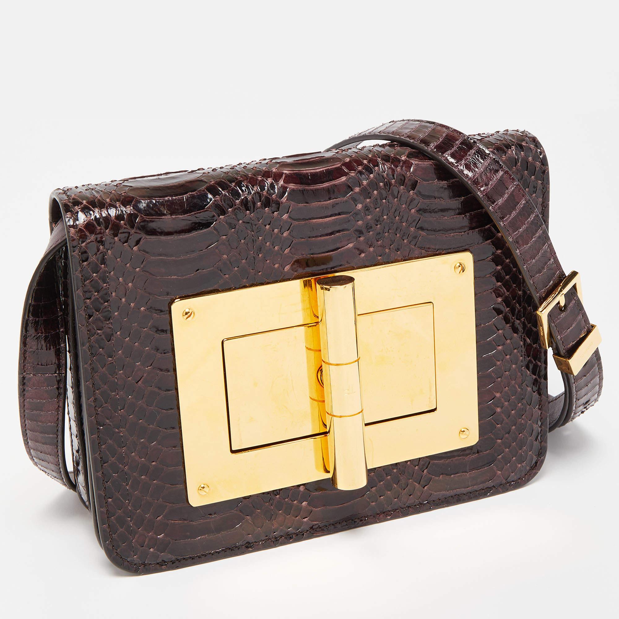 Trust this Tom Ford bag to be light, durable, and comfortable to carry. Crafted from exotic leather, it comes in a dark burgundy hue. It features an Alcantara interior, a long strap, and the signature twist lock at the front.

